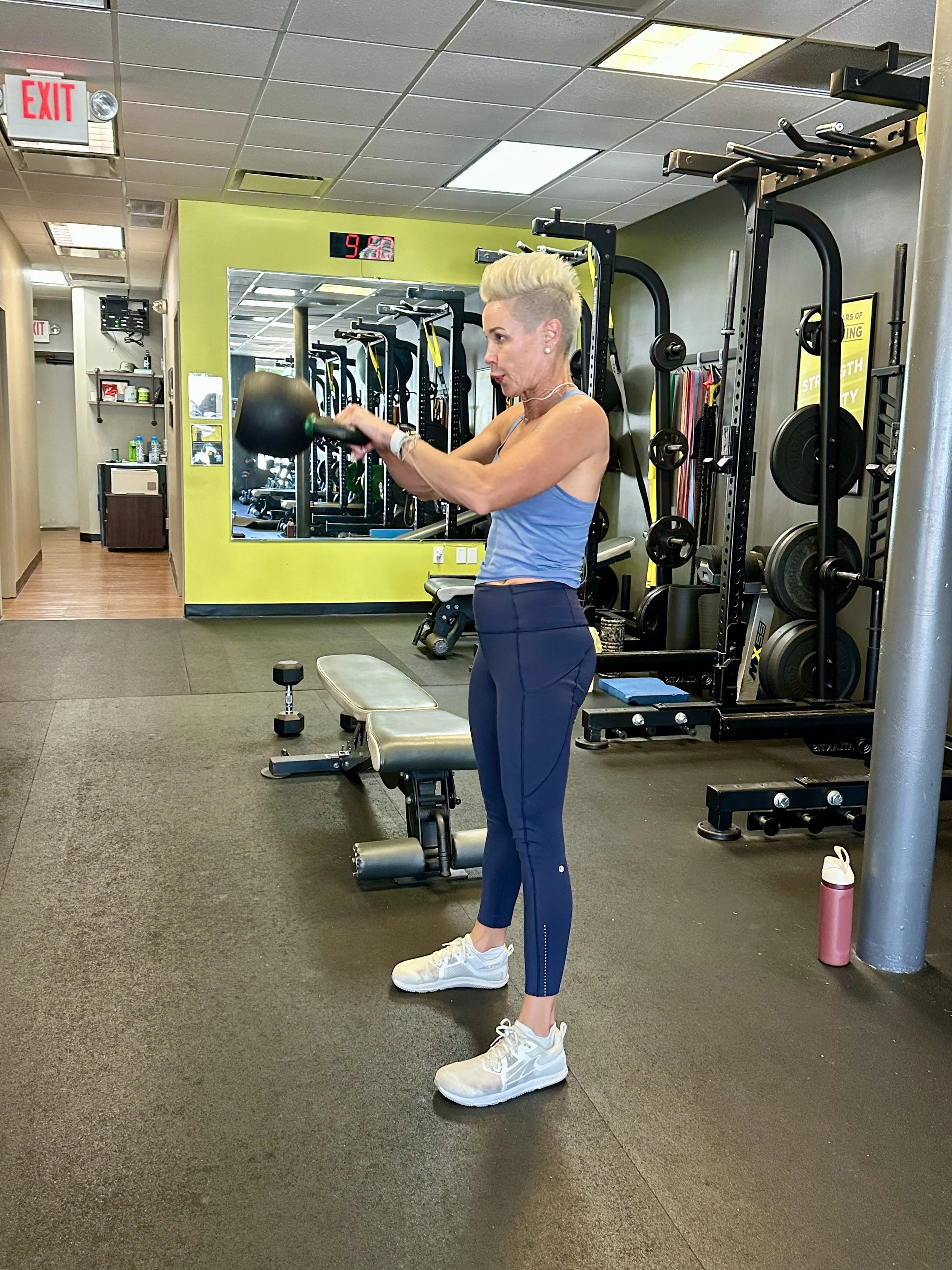 Woman over 40 performing kettlebell exercises during a strength training workout to build muscle, improve bone density, and support healthy aging