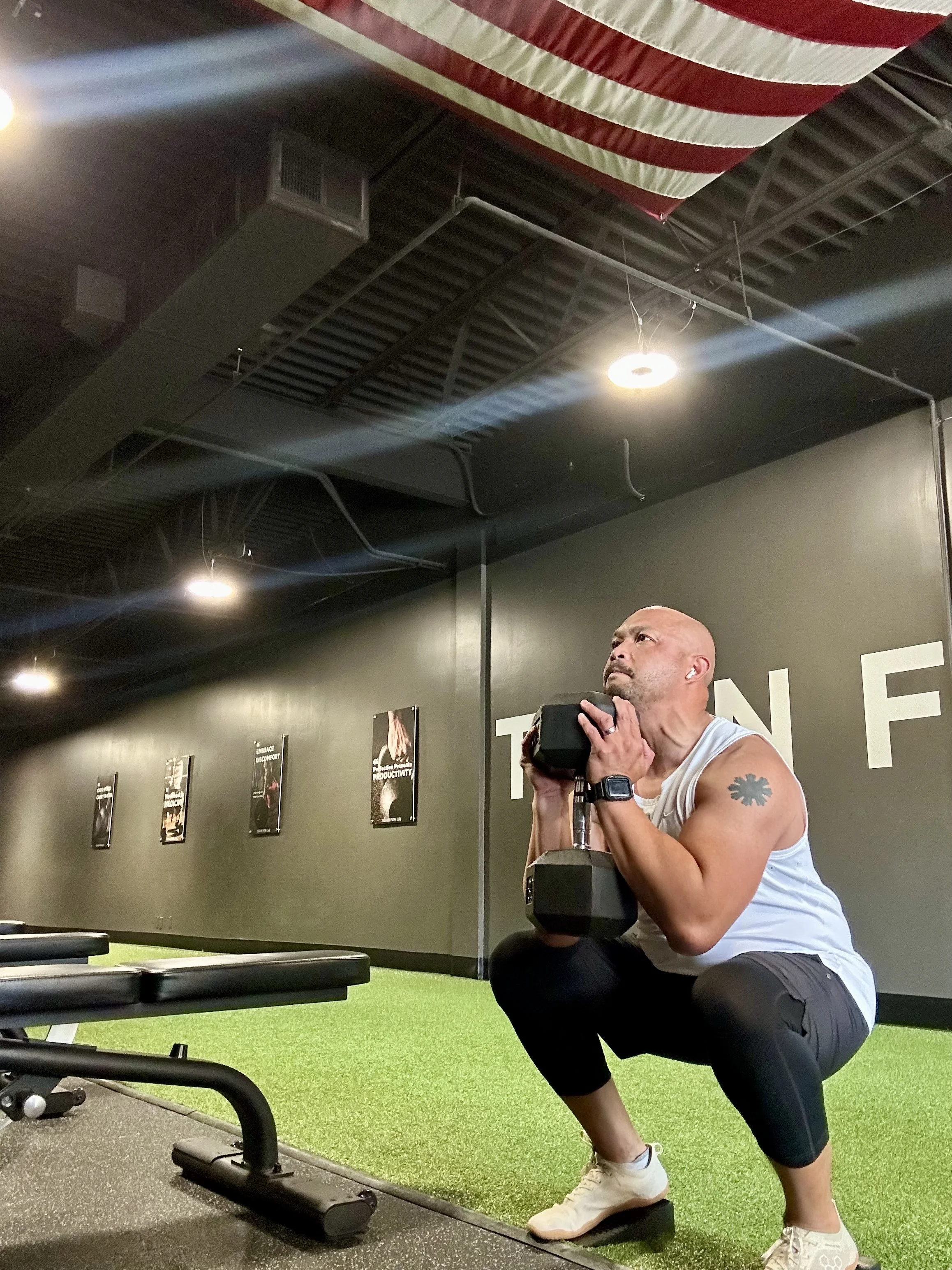 Adult performing goblet squat during strength training session at Functional Elements Training & Nutrition in Creve Coeur, Missouri.