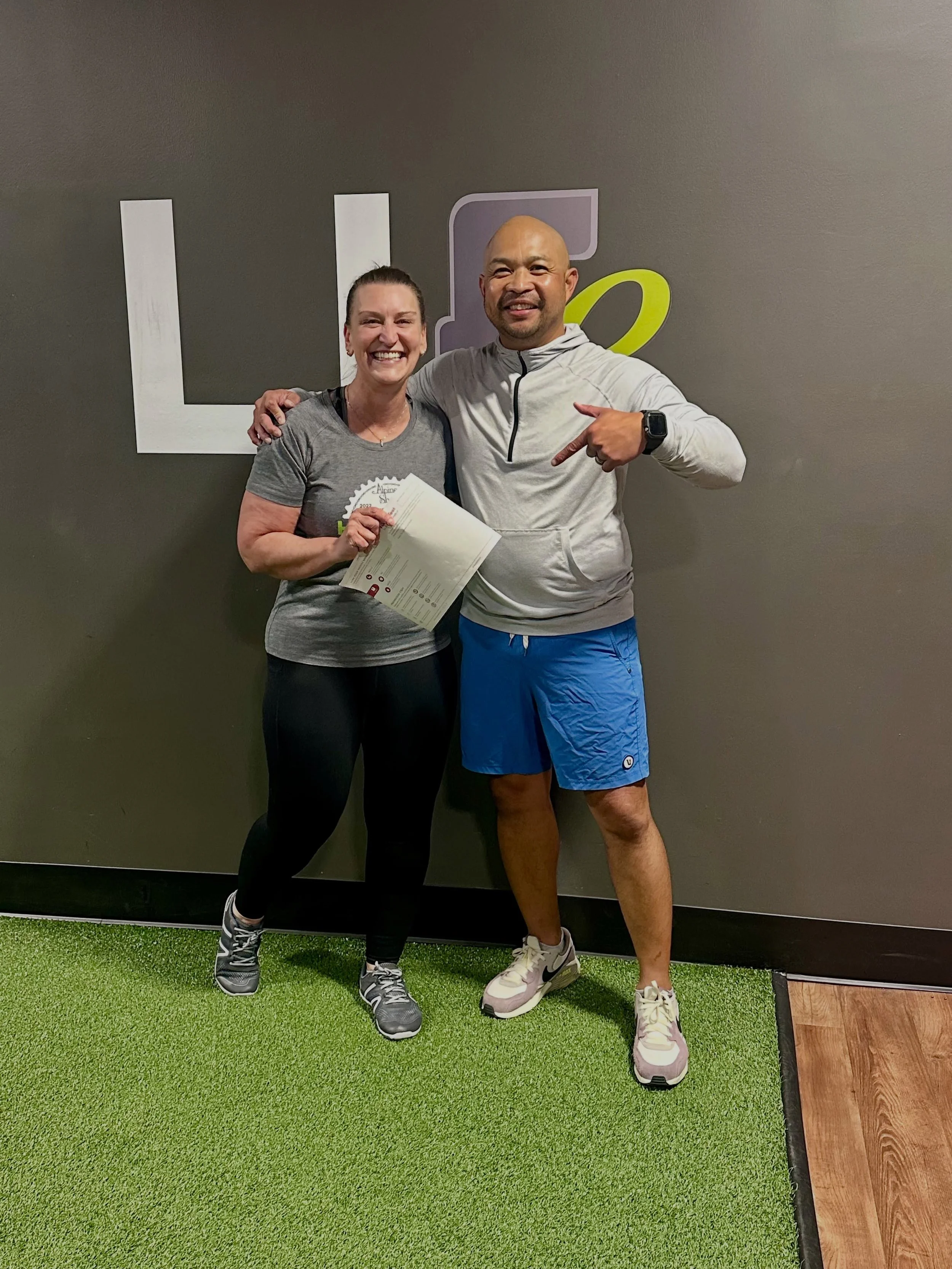 Functional Elements coach with a client holding InBody body composition results in Creve Coeur, Missouri.
