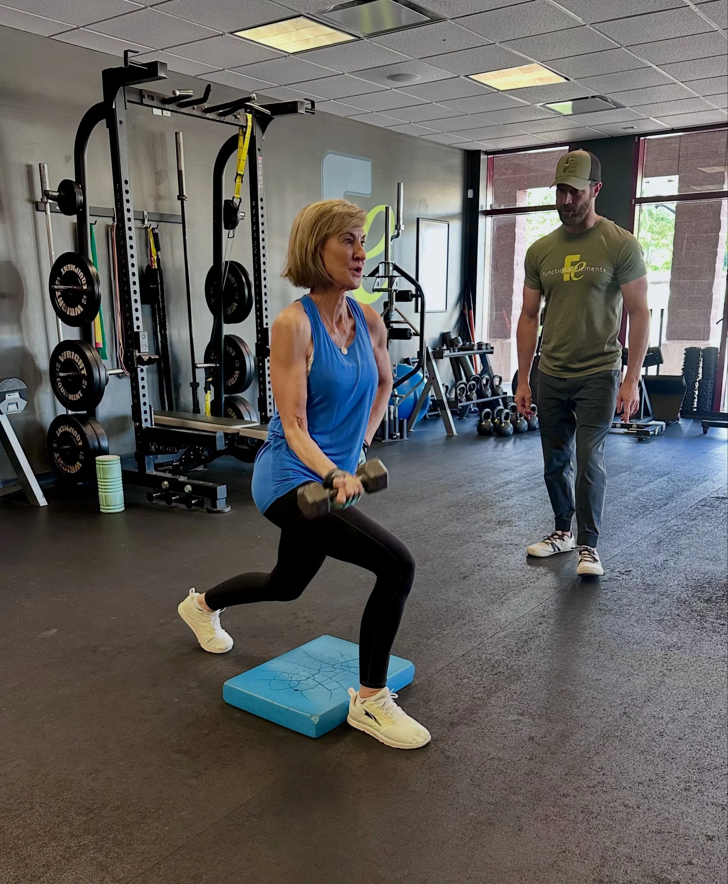 Woman strength training with a personal trainer at Functional Elements in Creve Coeur, MO