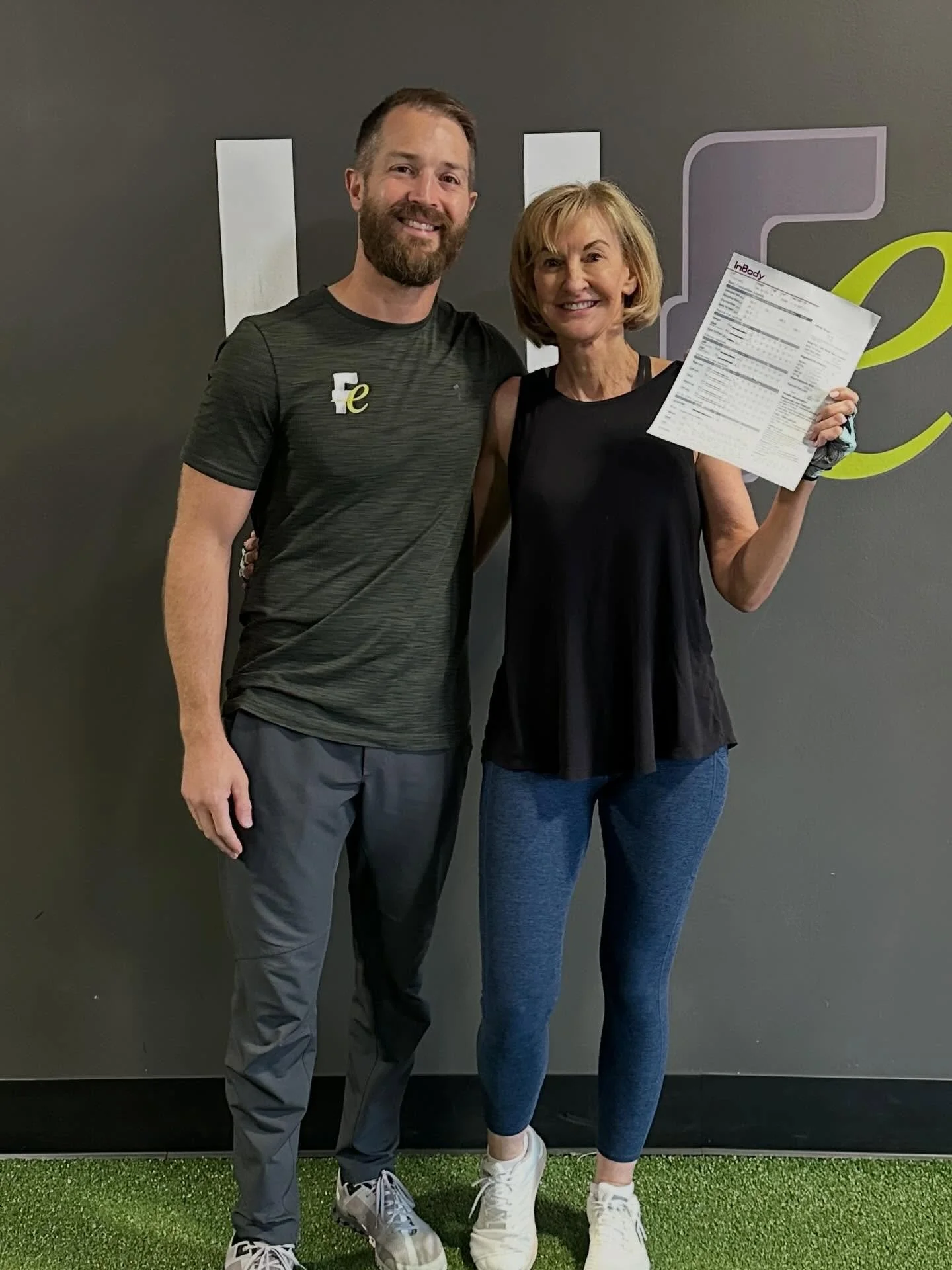 Functional Elements client reviewing her 10-week InBody body composition reassessment with a coach at FE Training & Nutrition in Creve Coeur, MO
