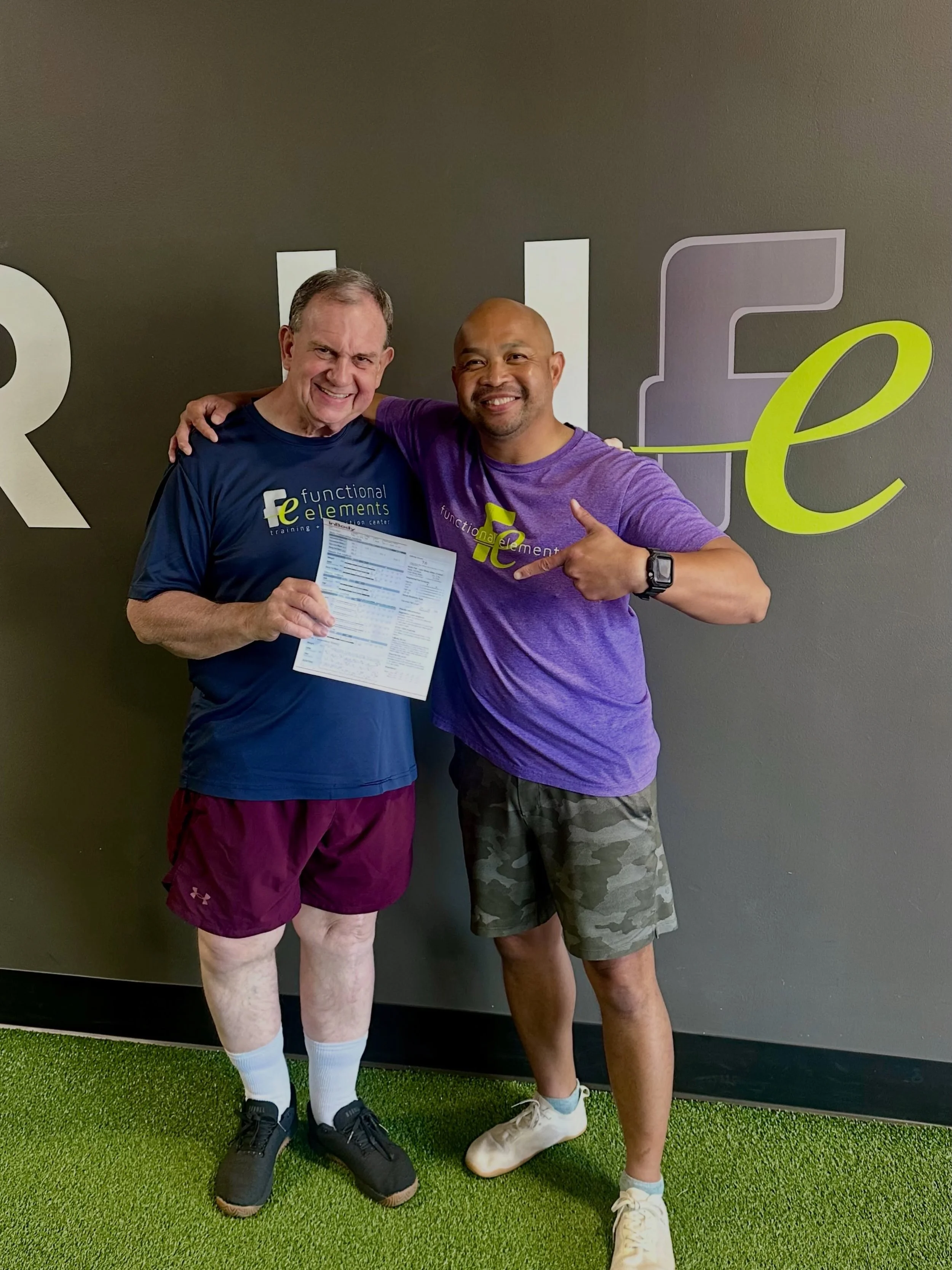 Client reviewing InBody body composition scan results with a coach at FE Training & Nutrition in Creve Coeur, MO