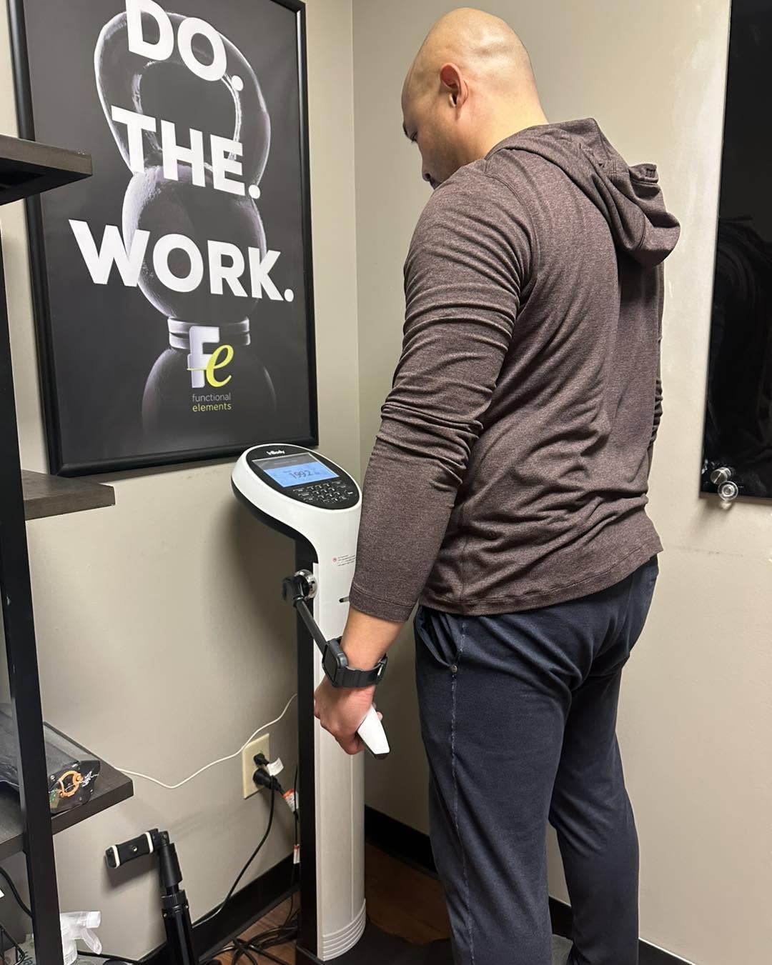 Client completing an InBody body composition scan at FE Training & Nutrition in Creve Coeur, MO