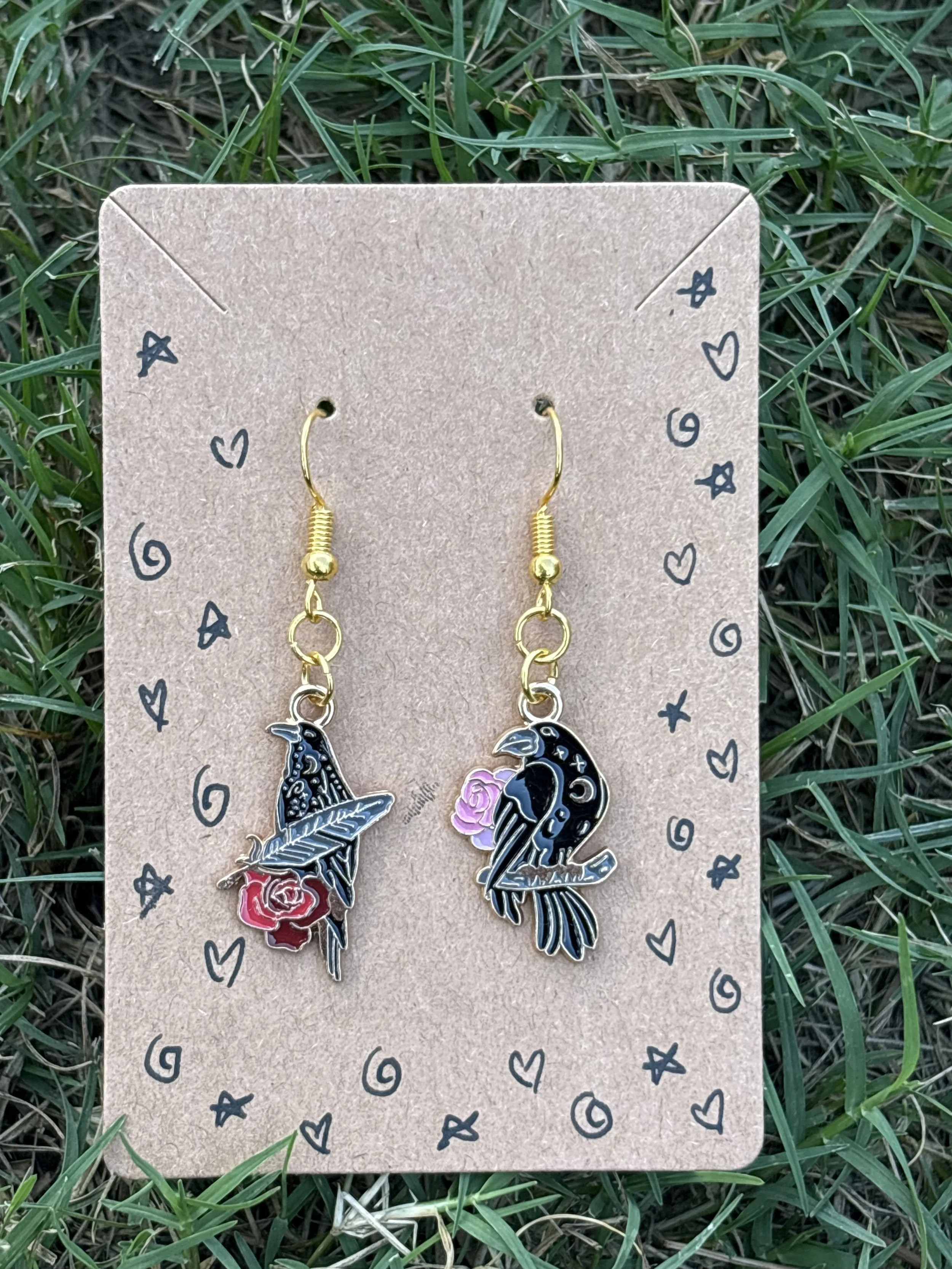 Asymmetrical crow with flowers earrings