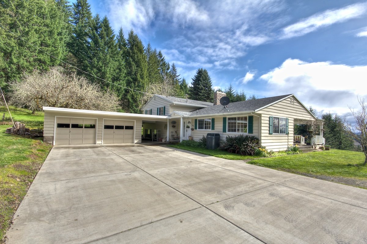 Driveway view of a house for sale in Buxton, Oregon