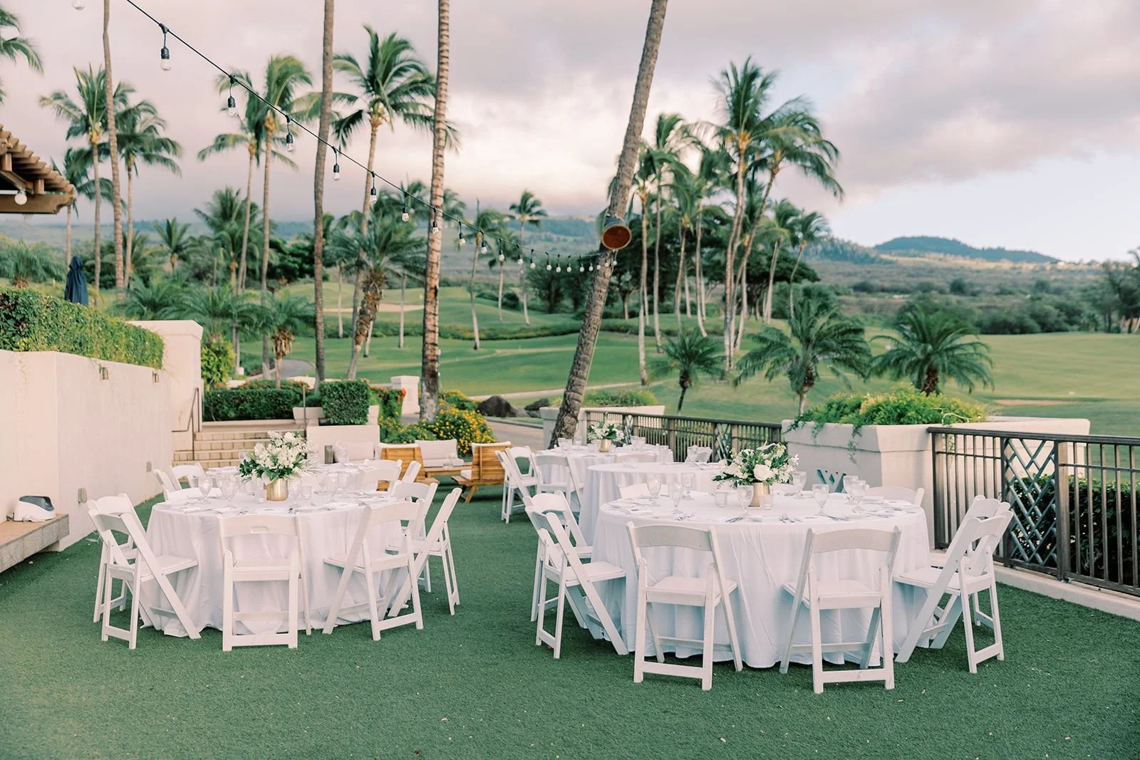 An outdoor tropical golf course wedding reception