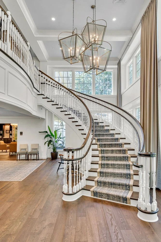 Restored hardwood floors sweep up a stunning curved staircase returning the stunning, historic vibe to the club after fire damage.