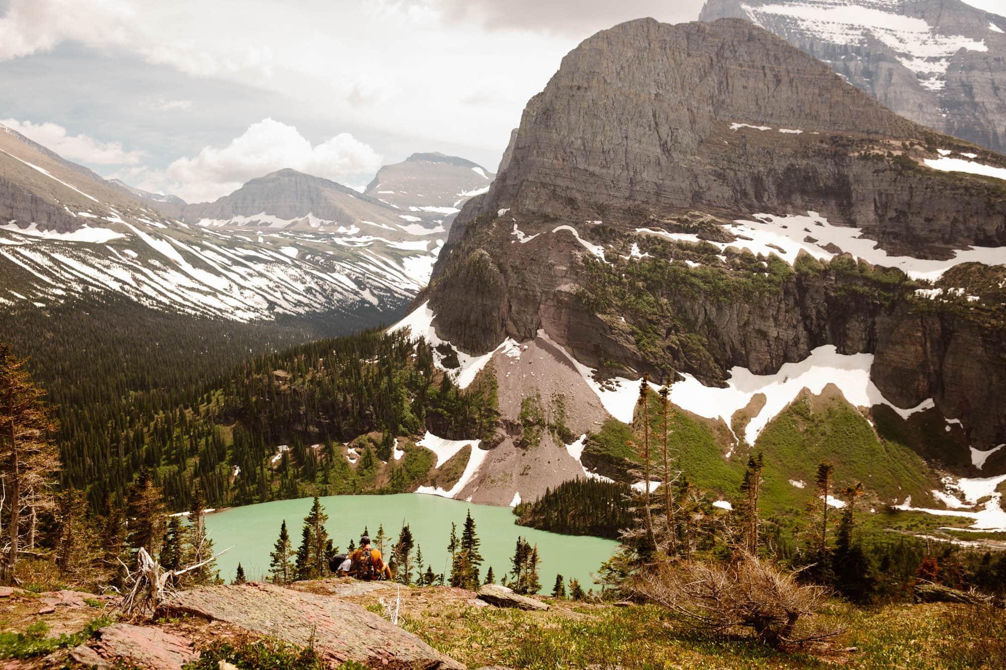 Glacier National Park engagement photo session images overlooking an alpine lake in the mountains of Montana