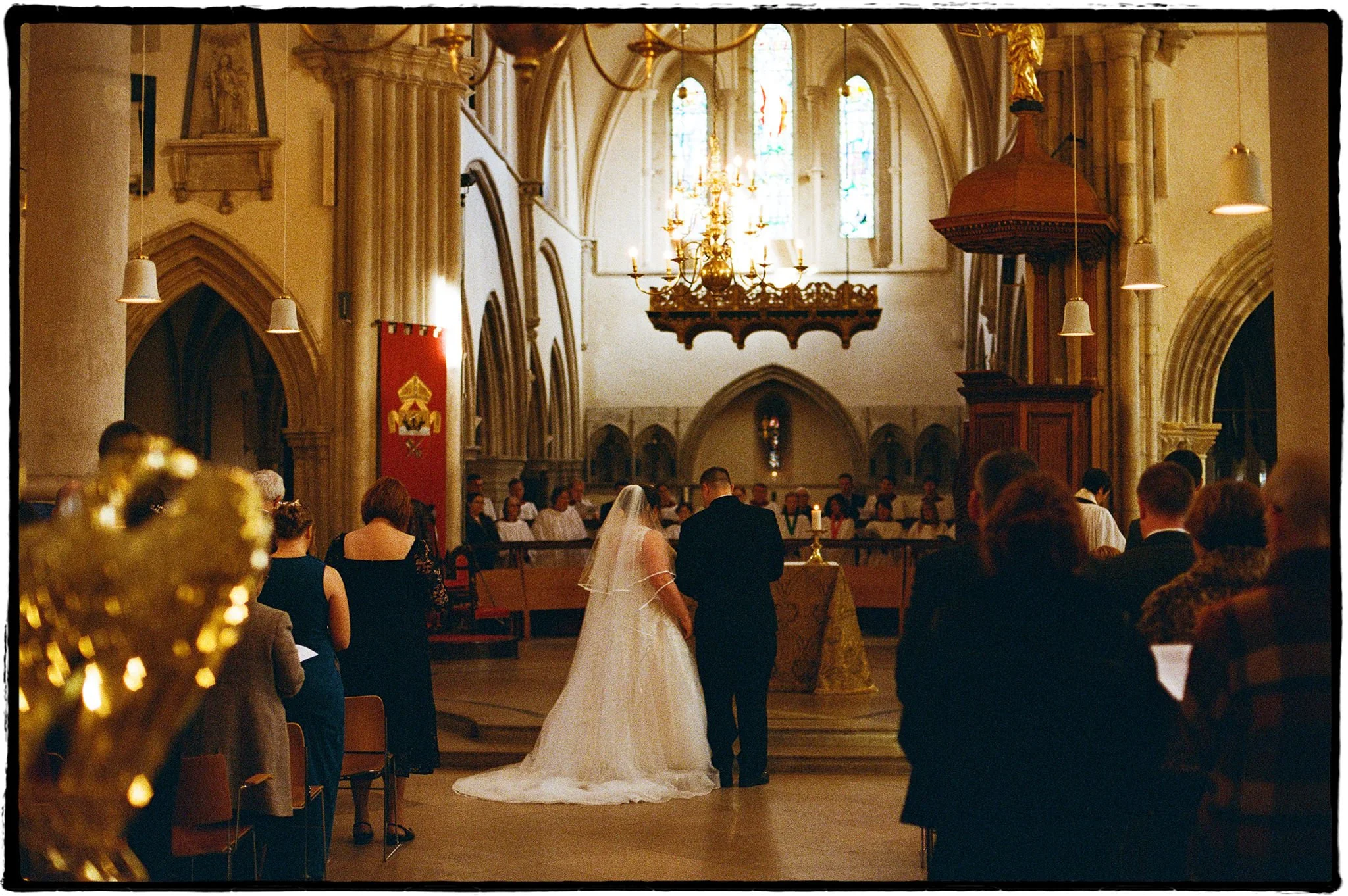 Film wedding photo of a bride & groom during their wedding ceremony in Portsmouth Cathedral.