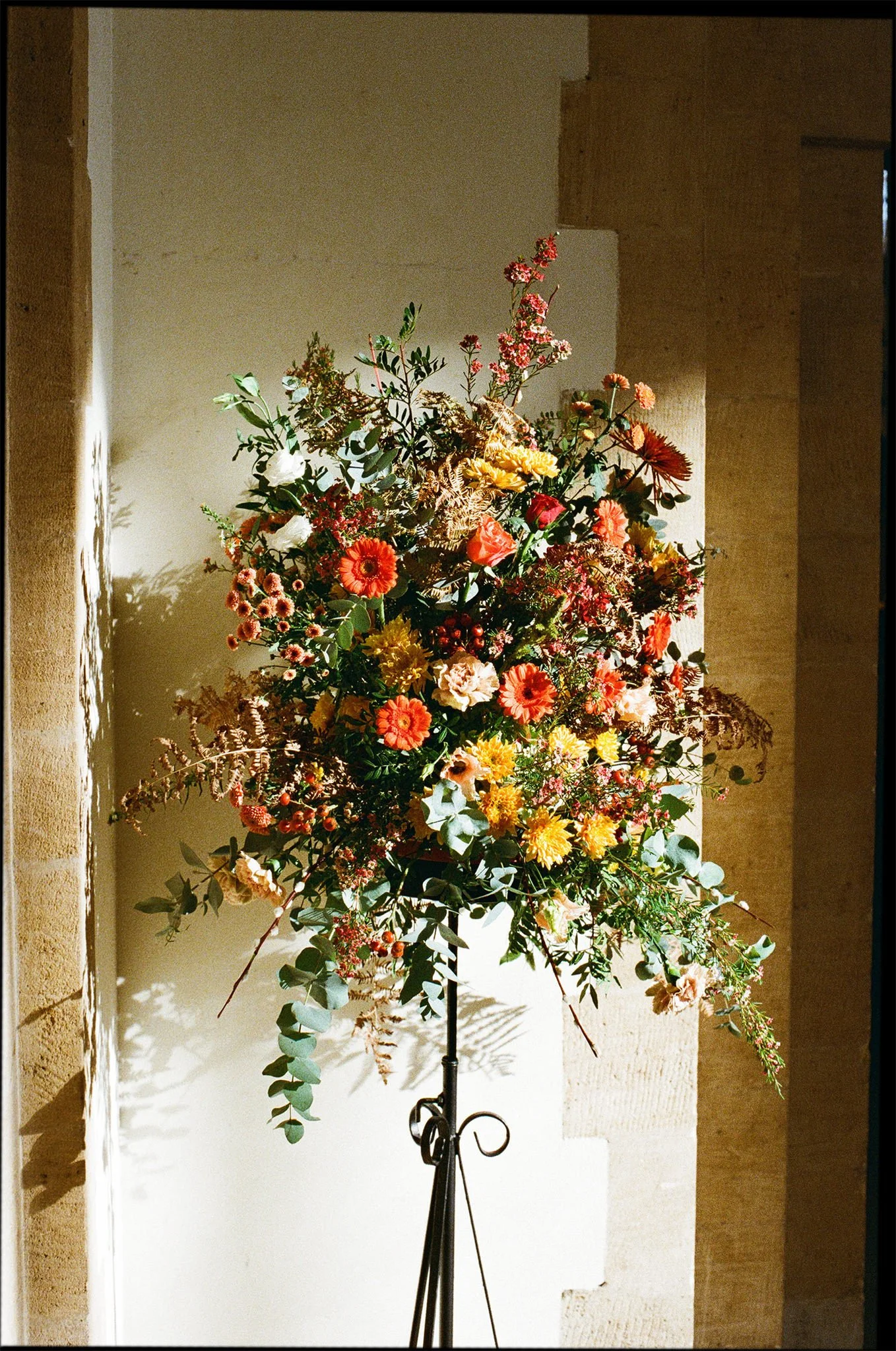 Film photo of a beautiful pedestal of flowers in harsh, bright sunlight in Portsmouth Cathedral