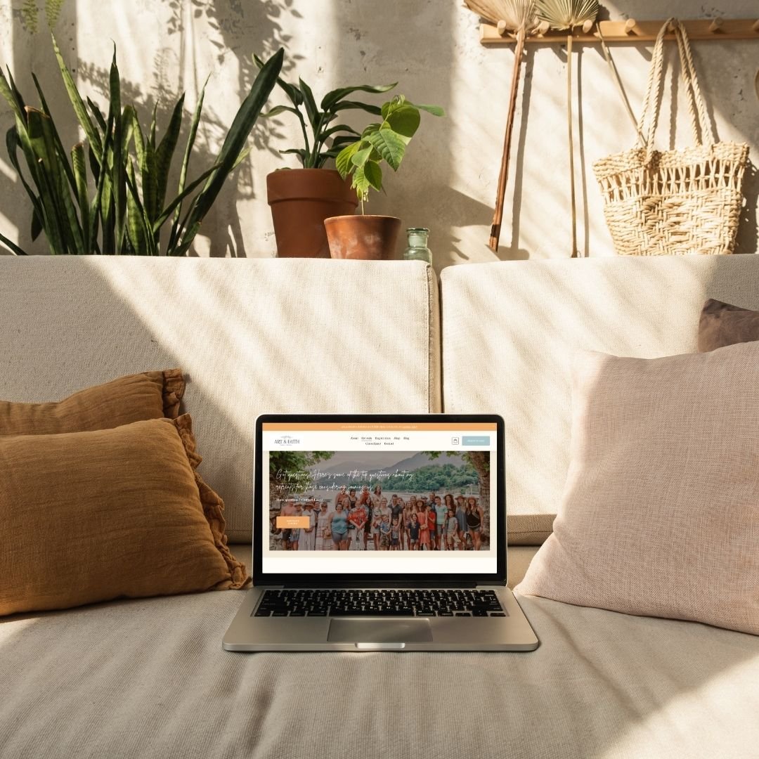 Retreat website design showcased on a MacBook lap top resting on a sofa