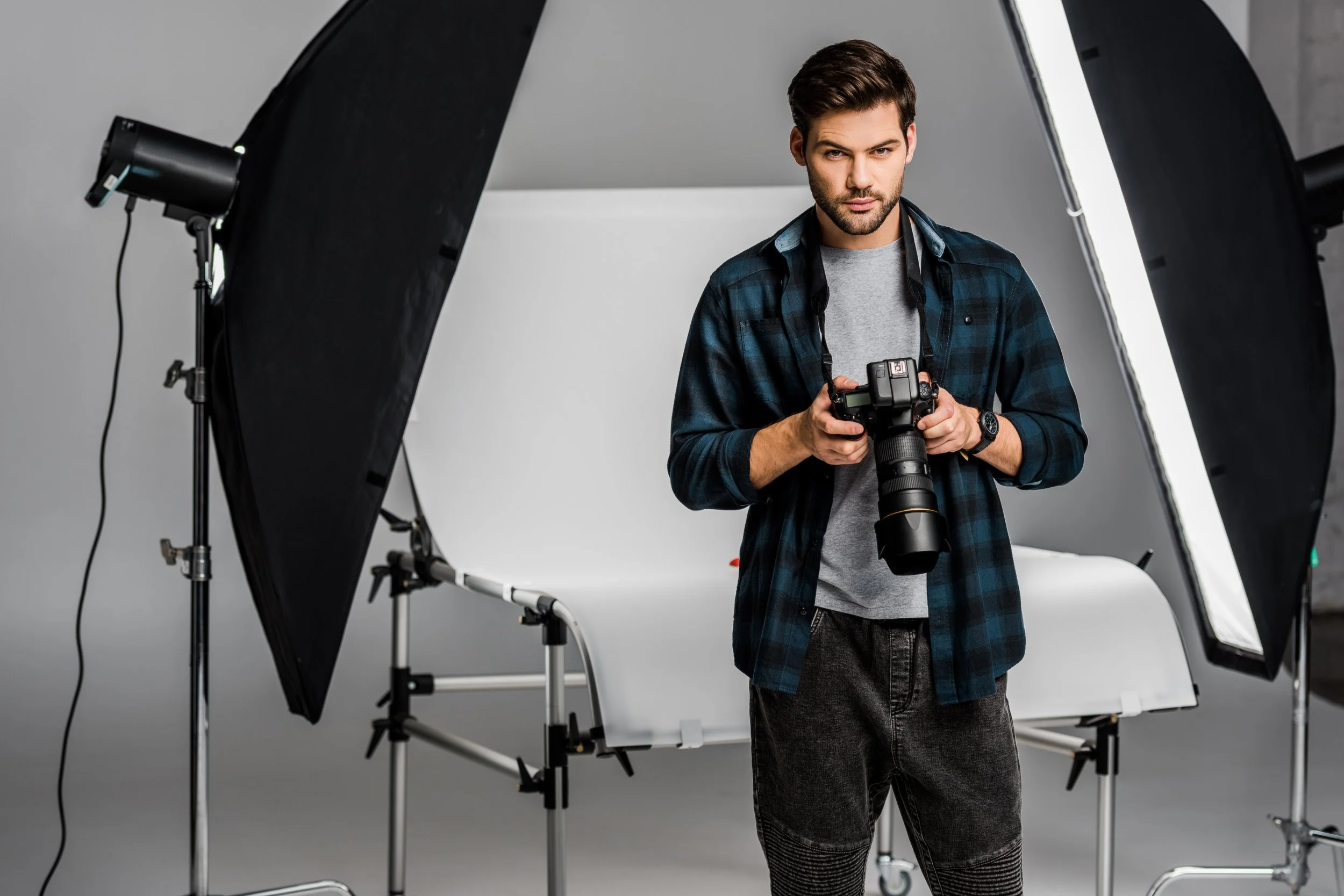 handsome-professional-young-photographer-using-cam-2022-12-16-17-10-40-utc.jpg