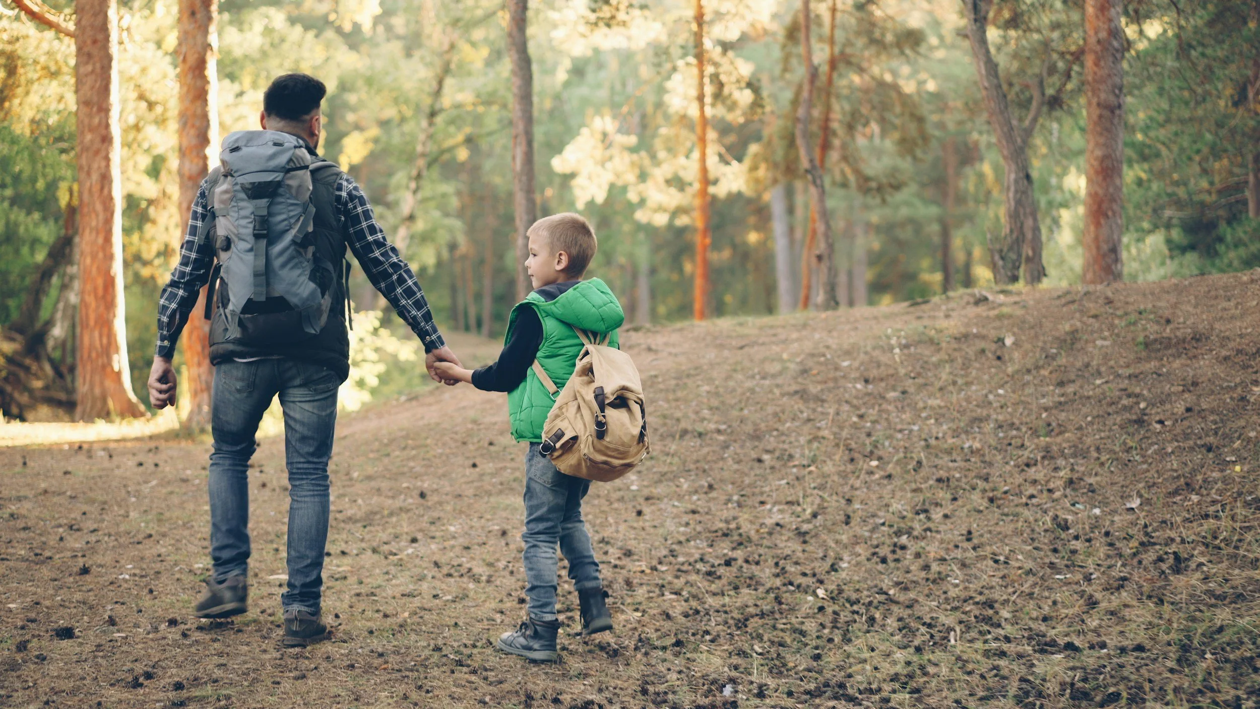 Father and son walking in the woods working on their conversation skills after speech therapy for conversation