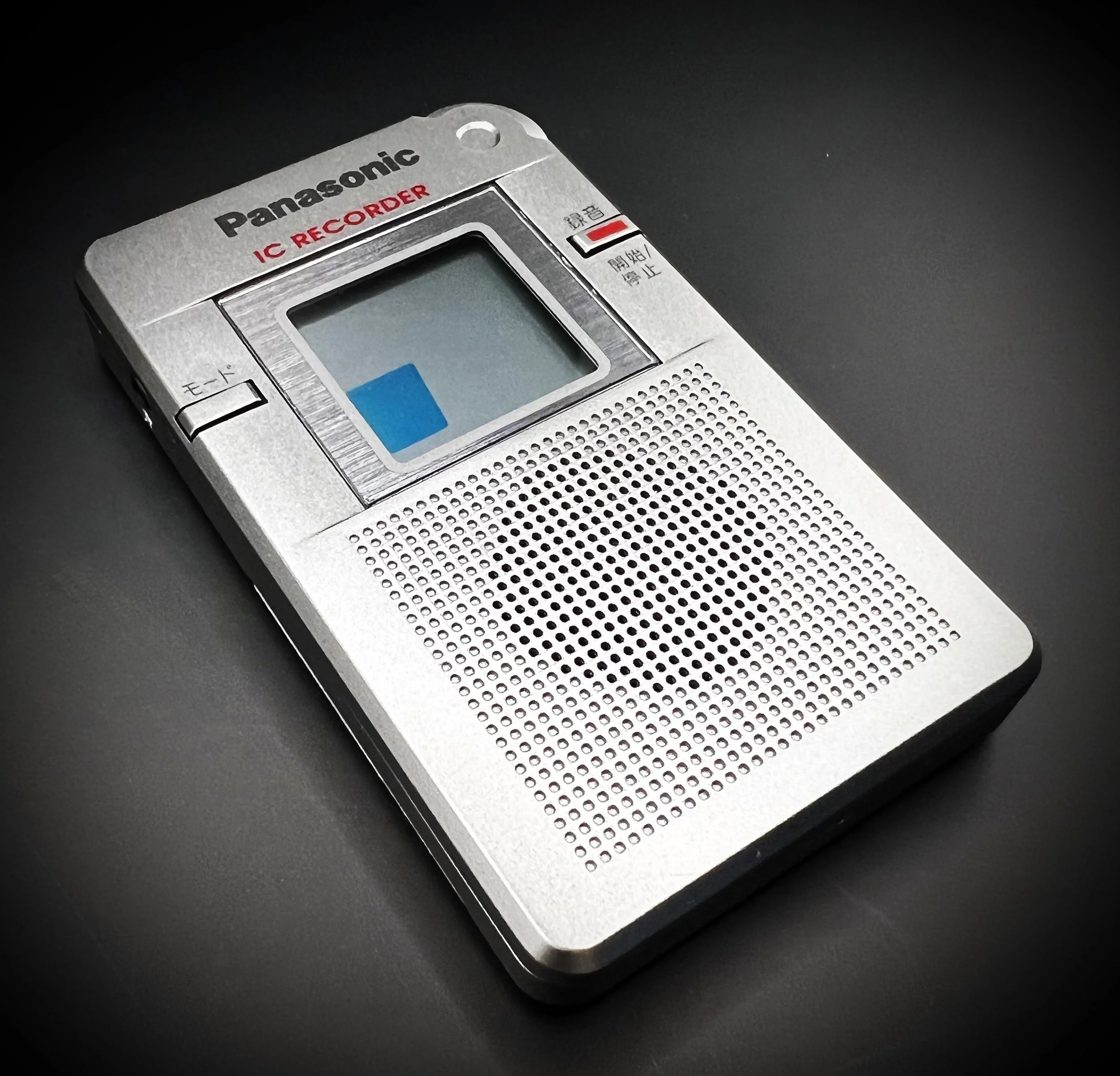 Panasonic RR-DR60 digital voice recorder left perspective view - black background