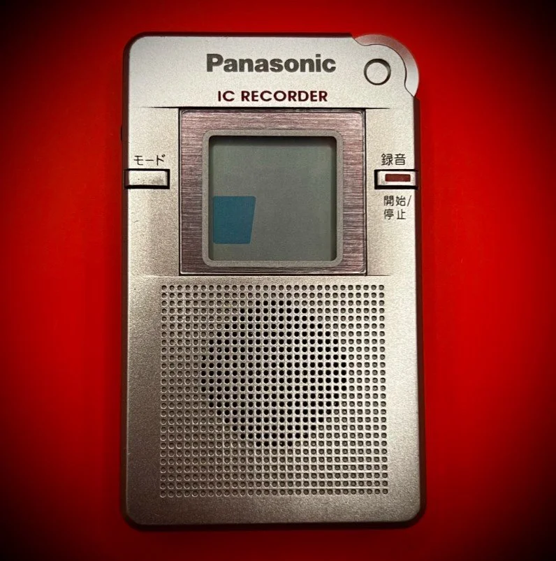 Panasonic RR-DR60 digital voice recorder front view - red background