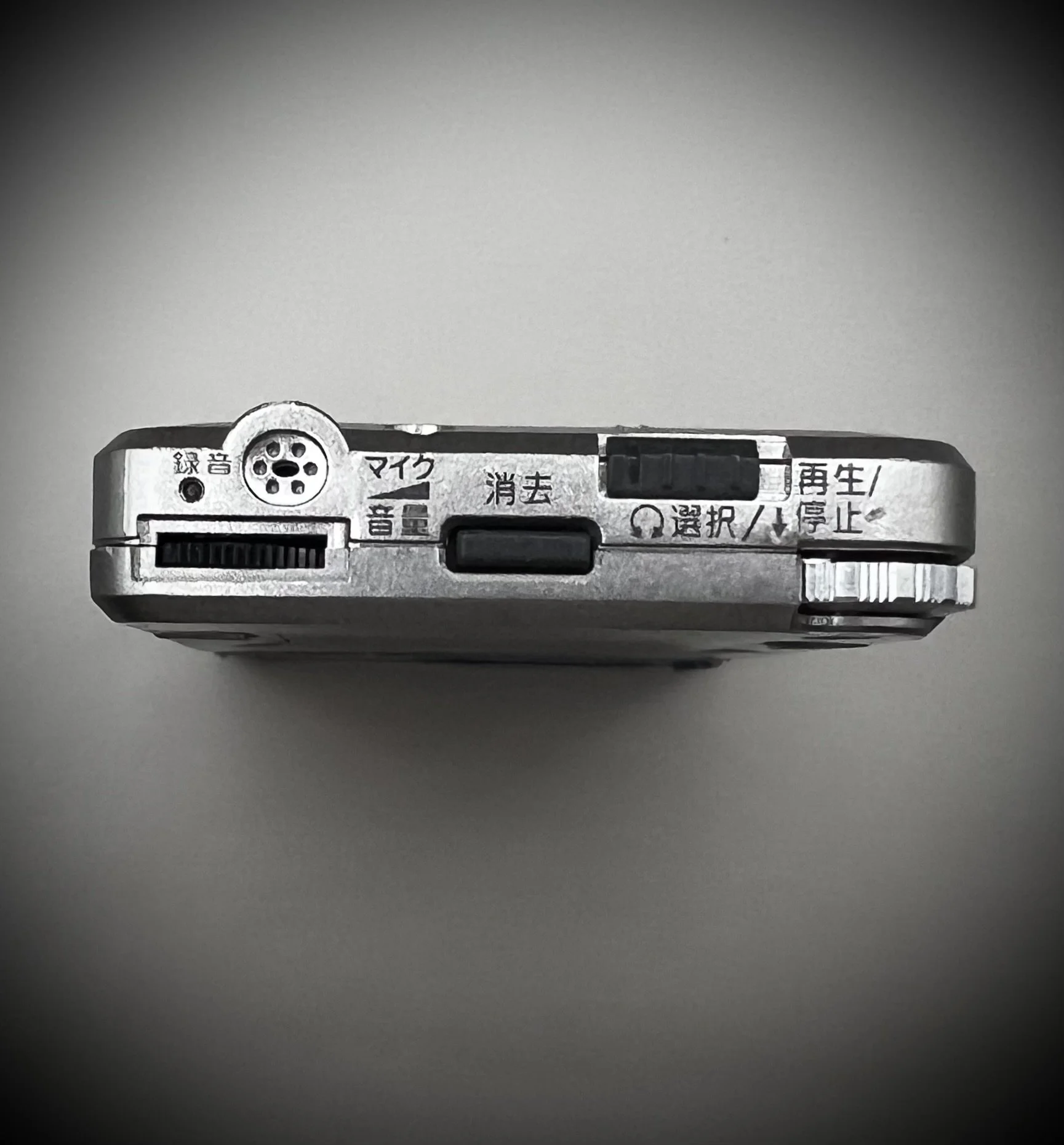 Panasonic RR-DR60 digital voice recorder top view - grey background