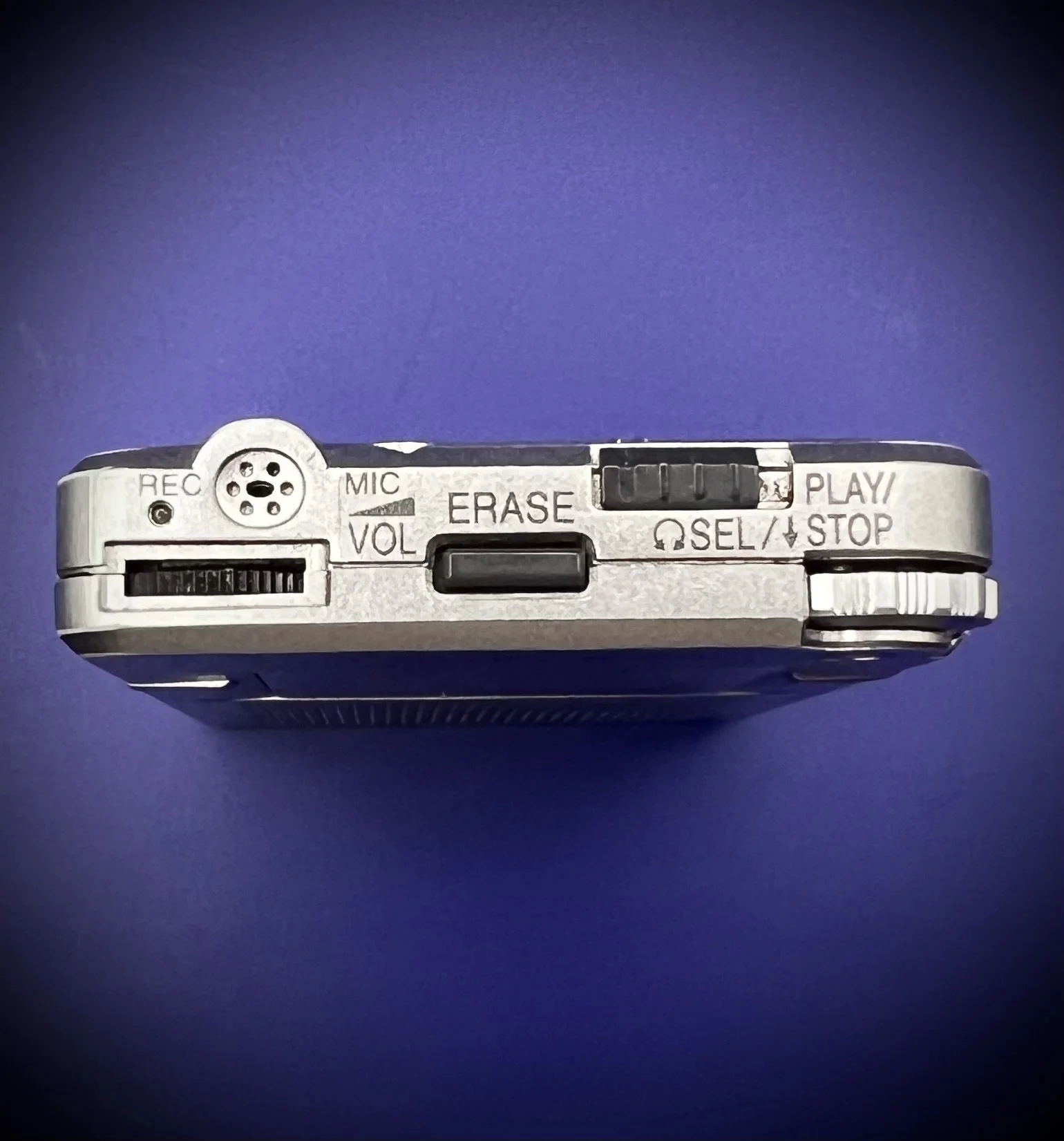 Panasonic RR-DR60 digital voice recorder top view - blue background