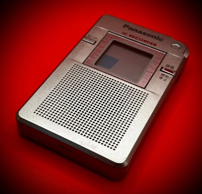 Panasonic RR-DR60 digital voice recorder right perspective view - red background