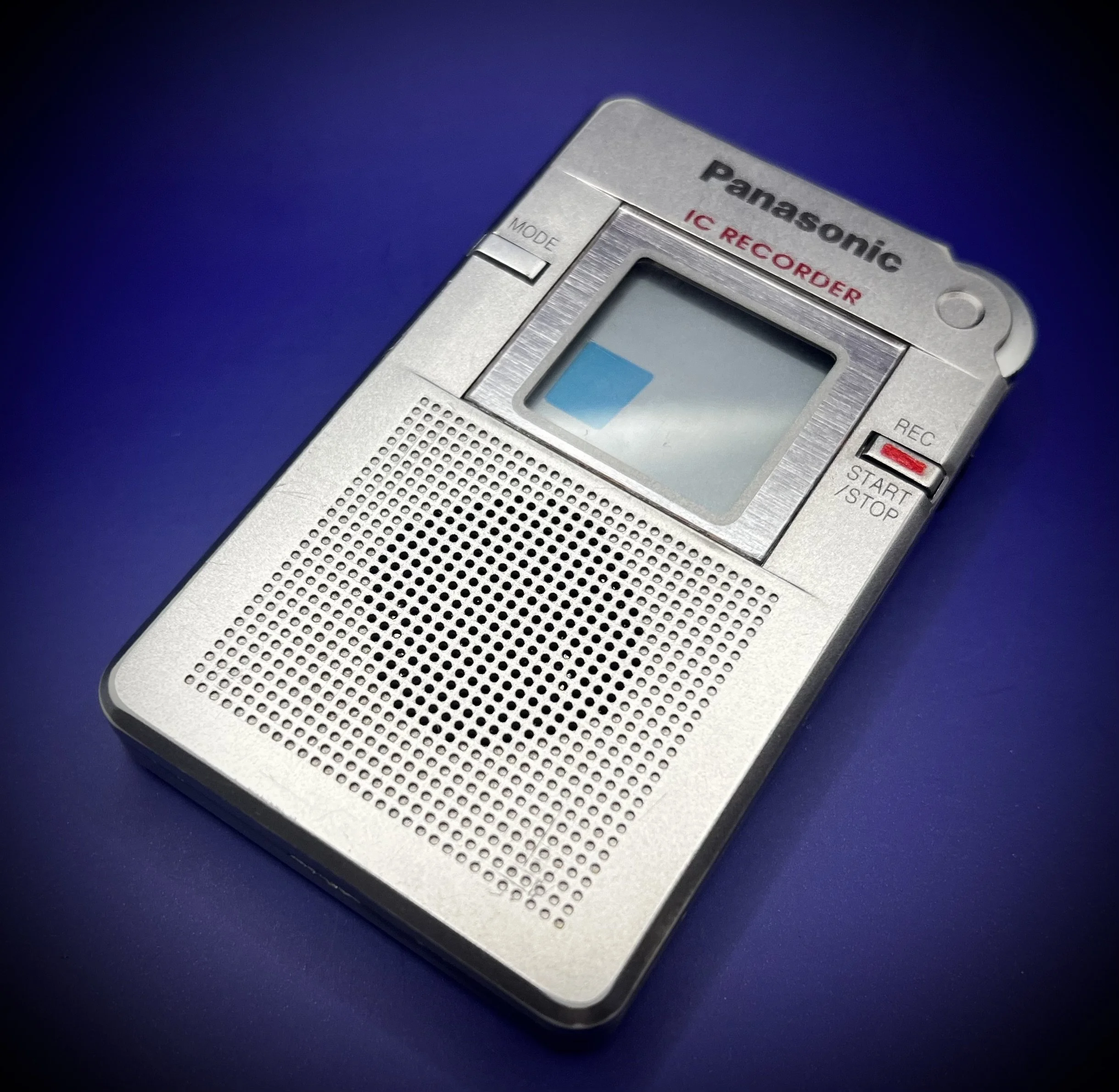 Panasonic RR-DR60 digital voice recorder right perspective view - blue background