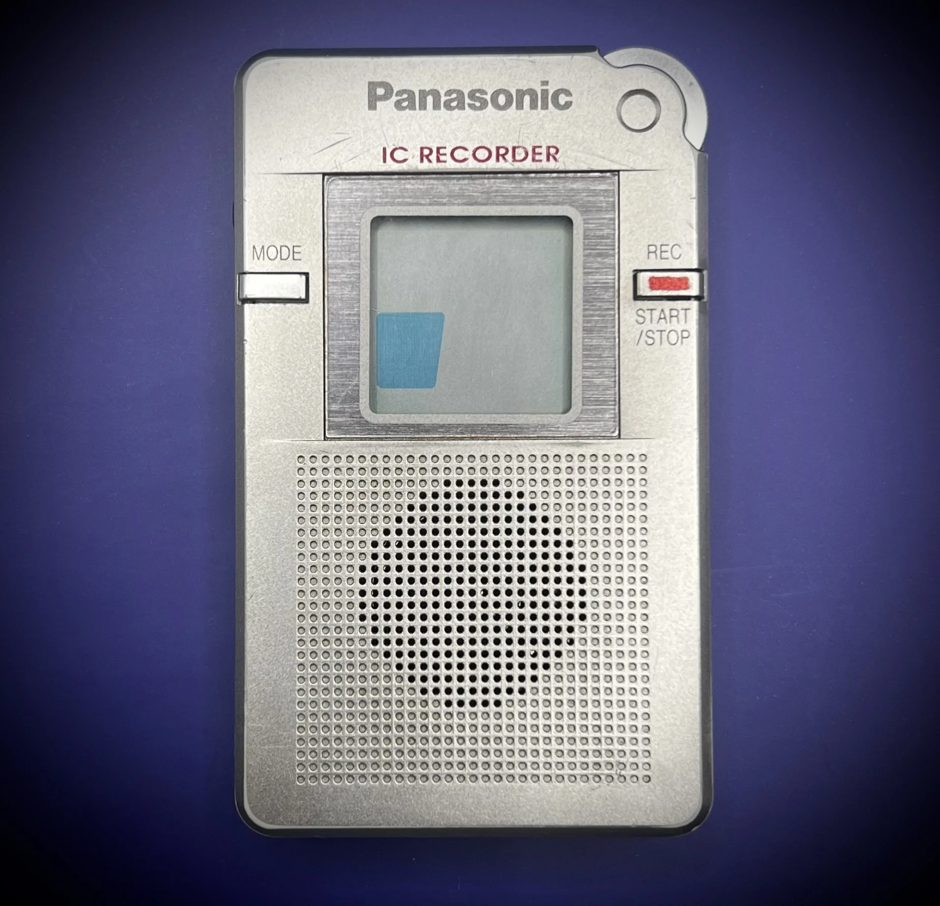 Panasonic RR-DR60 digital voice recorder front view - blue background