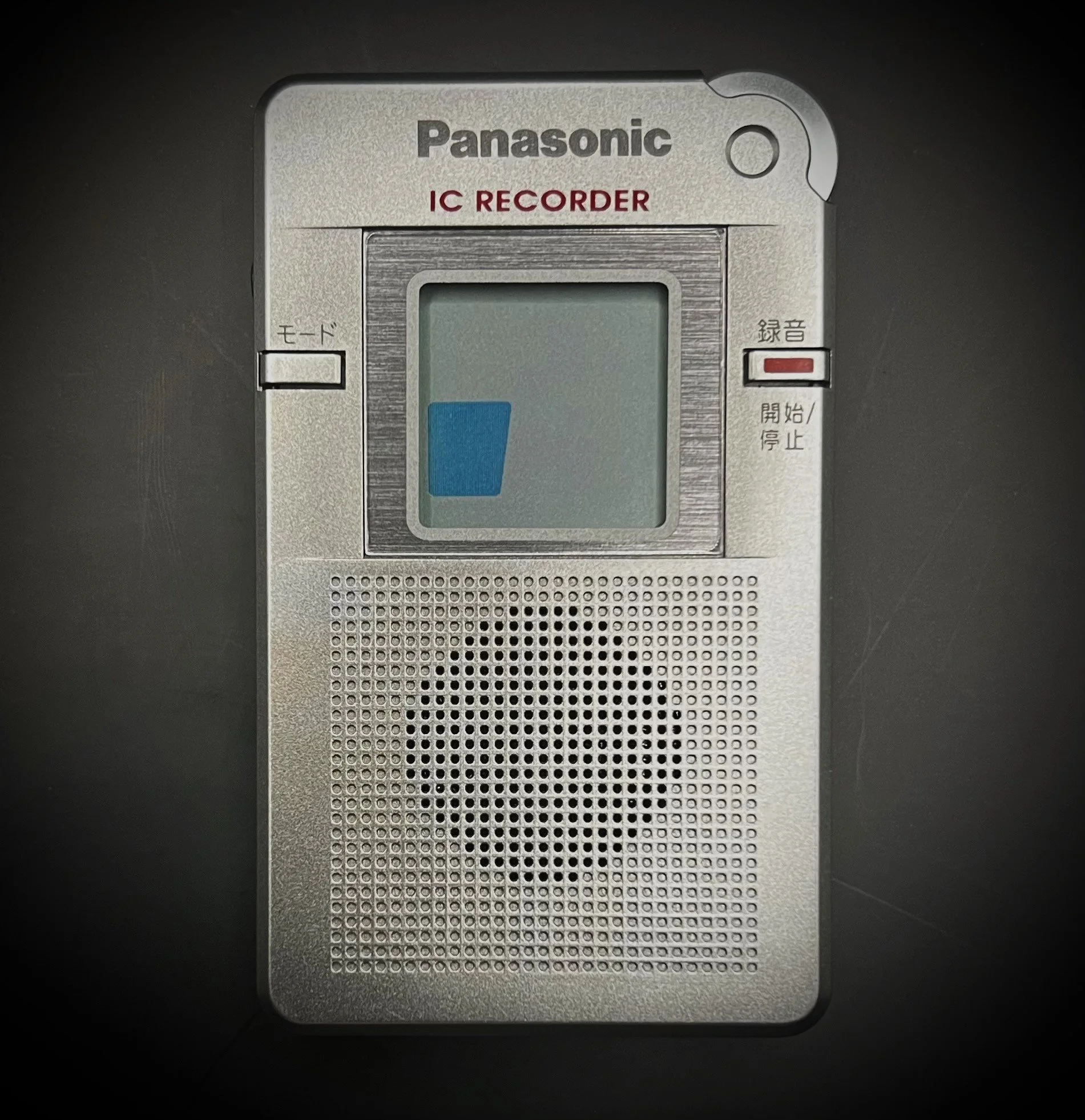 Panasonic RR-DR60 digital voice recorder front view - black background