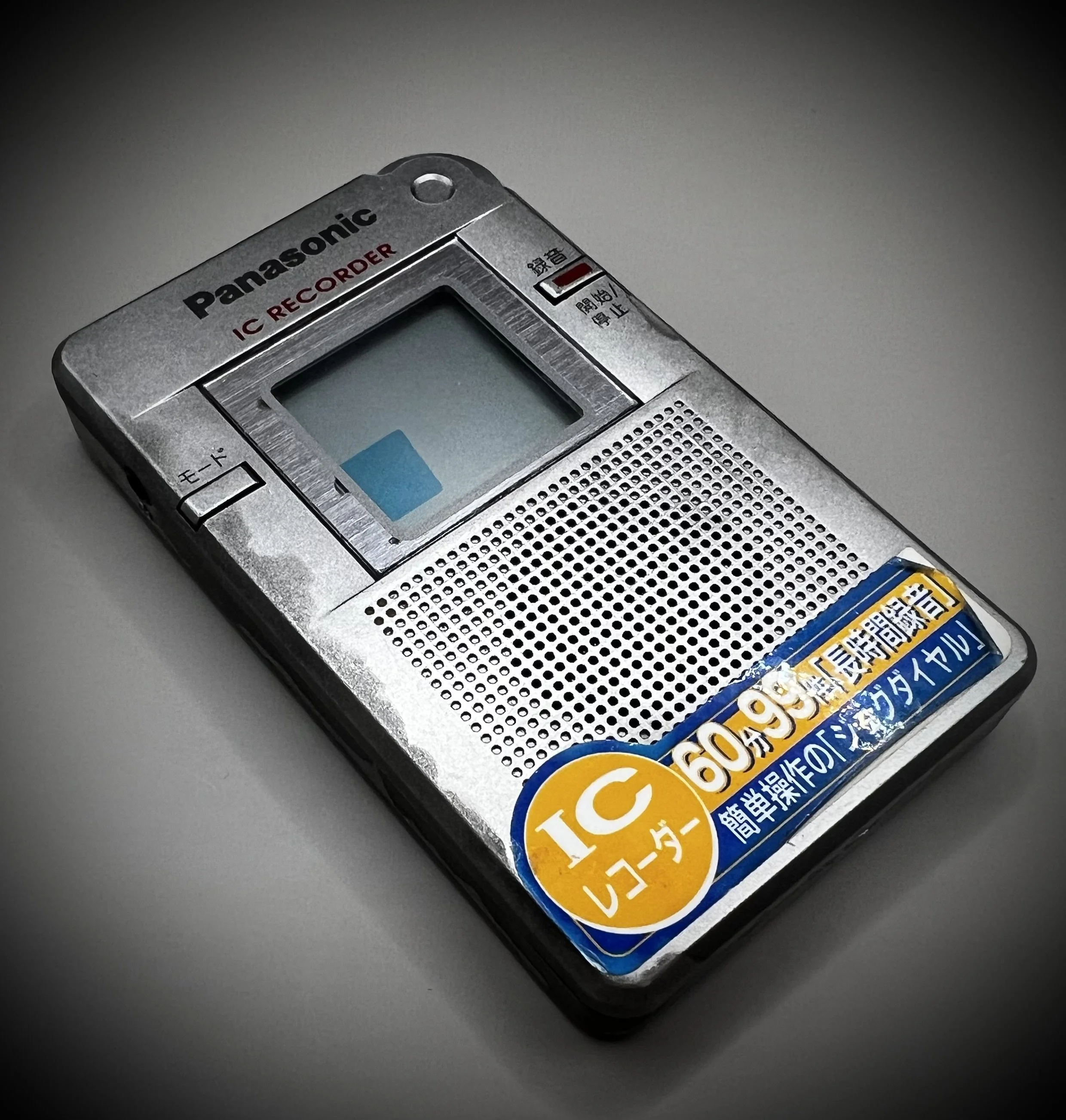 Panasonic RR-DR60 digital voice recorder left perspective view - grey background