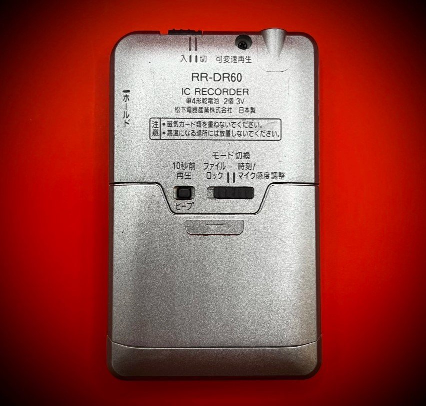 Panasonic RR-DR60 digital voice recorder back view - red background