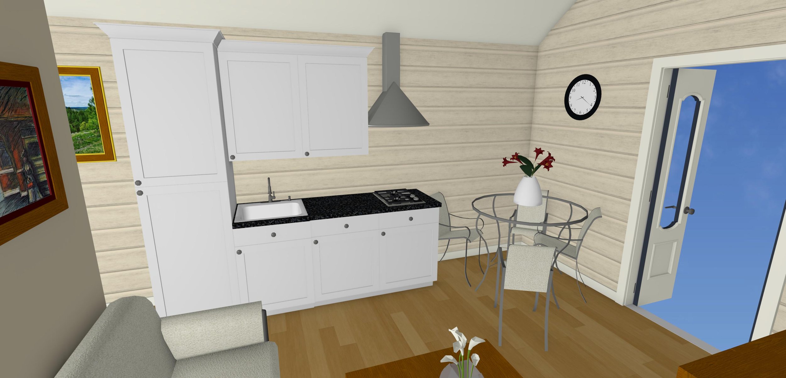 Modern kitchen interior with white cabinetry, black countertops, gas stove, and a round glass dining table with metal chairs. The walls are wood-paneled. A clock and framed artwork are mounted on the wall. A vase with red flowers is on the table. An