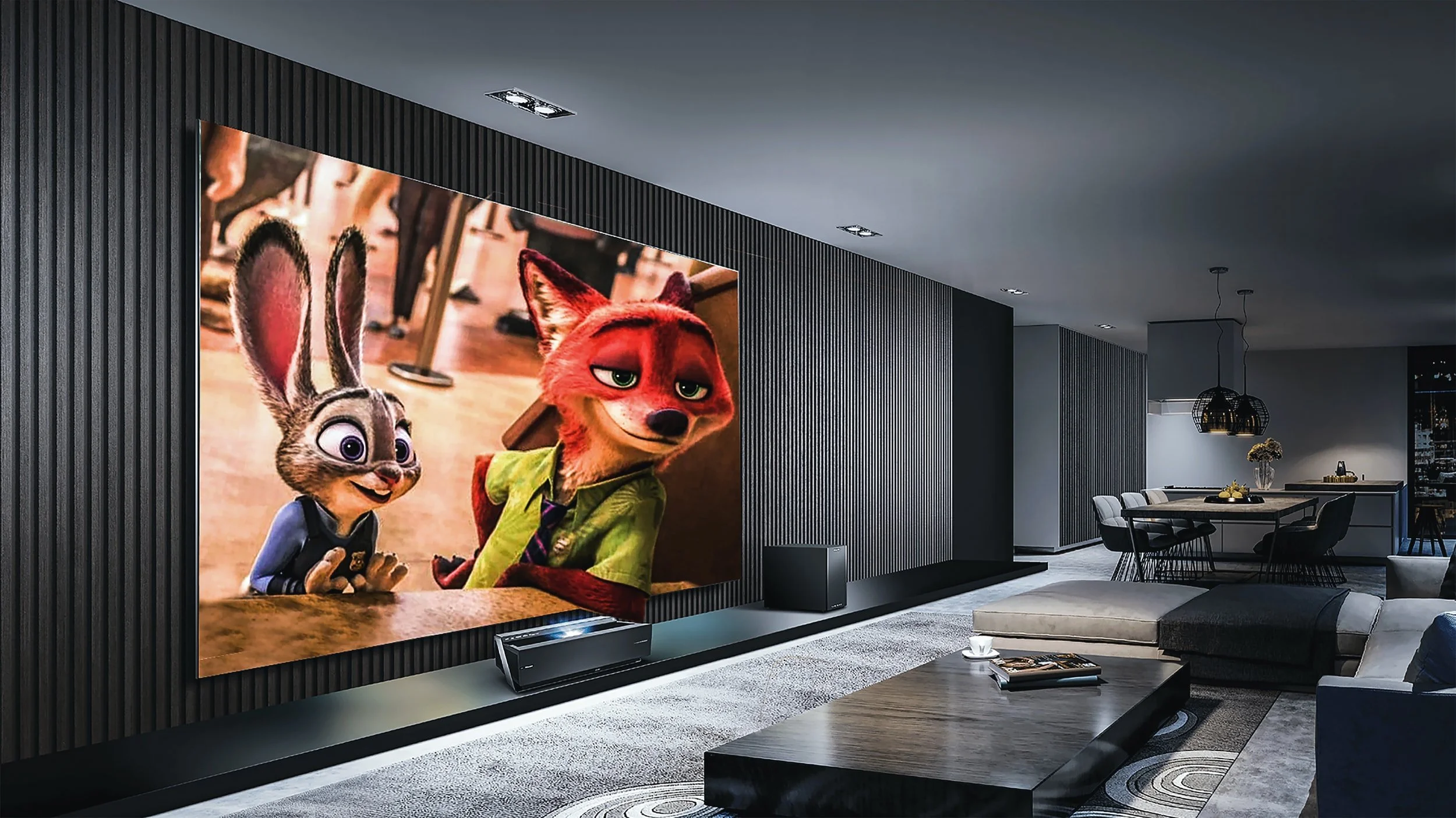 A modern living room featuring a large TV screen displaying animated characters Nick Wilde and Judy Hopps from Zootopia. The room has a black textured accent wall, a sleek low-profile entertainment unit, and contemporary furniture including a sectional sofa, coffee table, and a dining area in the background with hanging light fixtures and decorative elements.