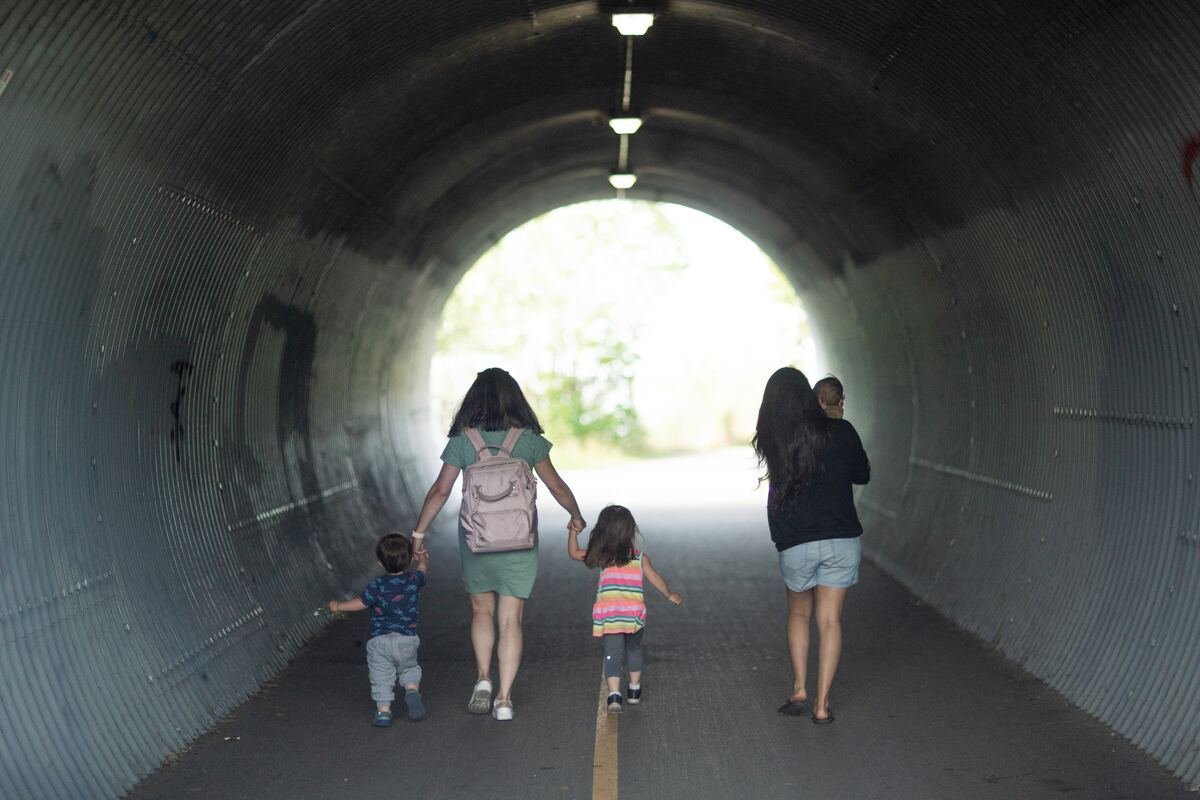 family walking through a tunnel