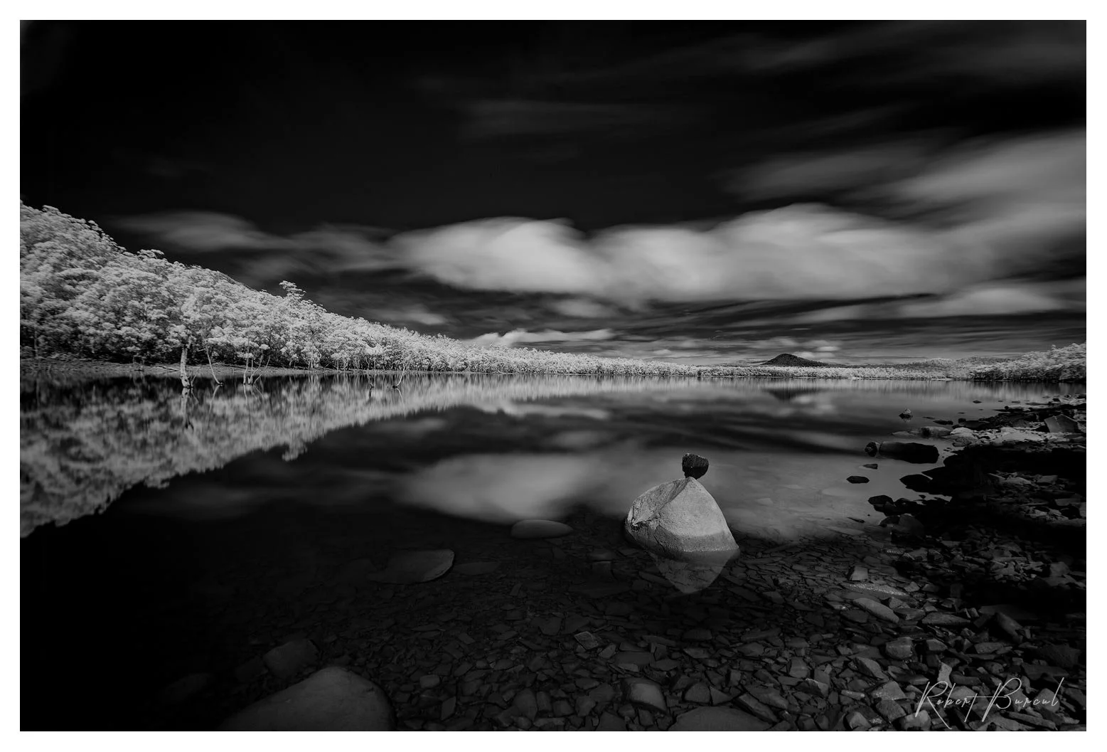 infrared black and white landscape image of lagoon