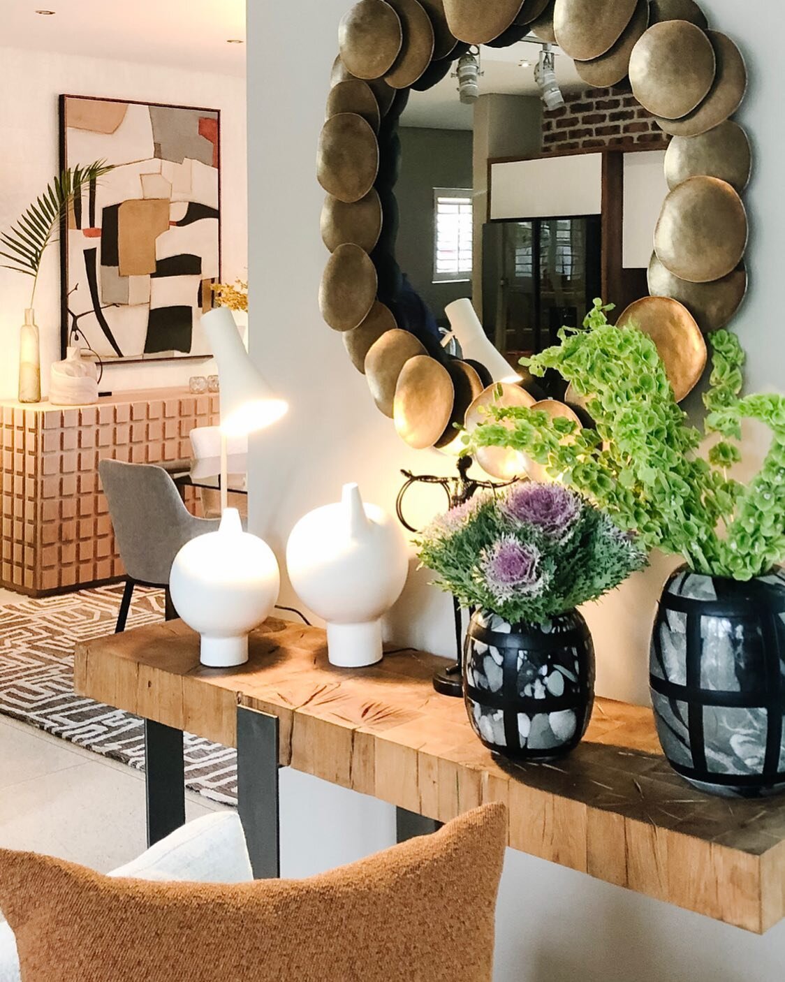 Happy Friday! Here's a shot from a recent installation to lift your spirits. We used an eclectic mix of objet and textures in the room - a vibrant rug, luxe mirror and cozy velvet cushions help to add charm, while statement art and pops of greenery b