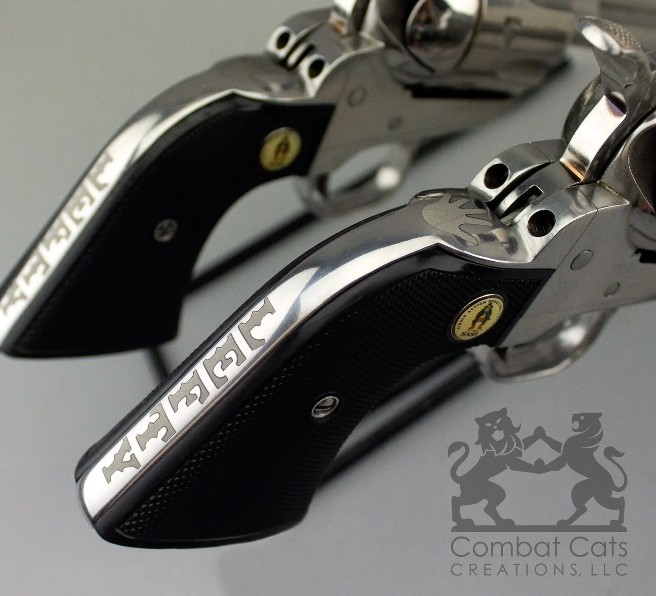 SASS Revolvers with personalized laser-engraved backstrap designs.