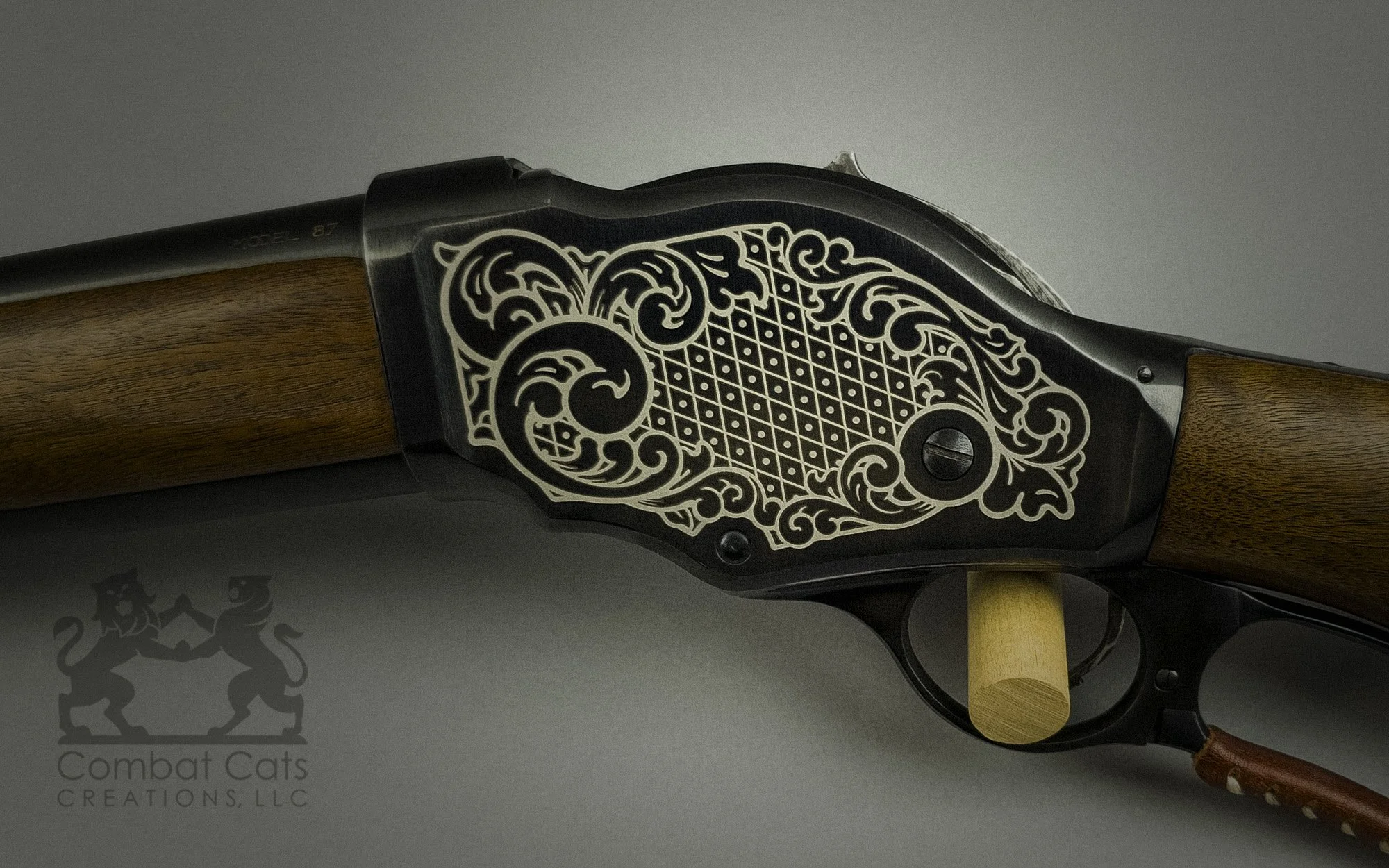 Cimarron 1887 Riot 12 GA shotgun featuring ornate scrollwork laser engraving, adding a distinctive touch to a classic design.