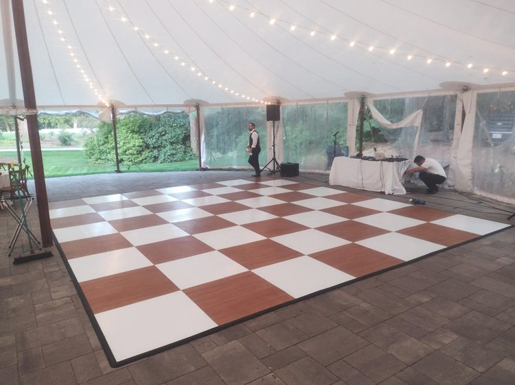 Honey and white checkered dance floor under a tent