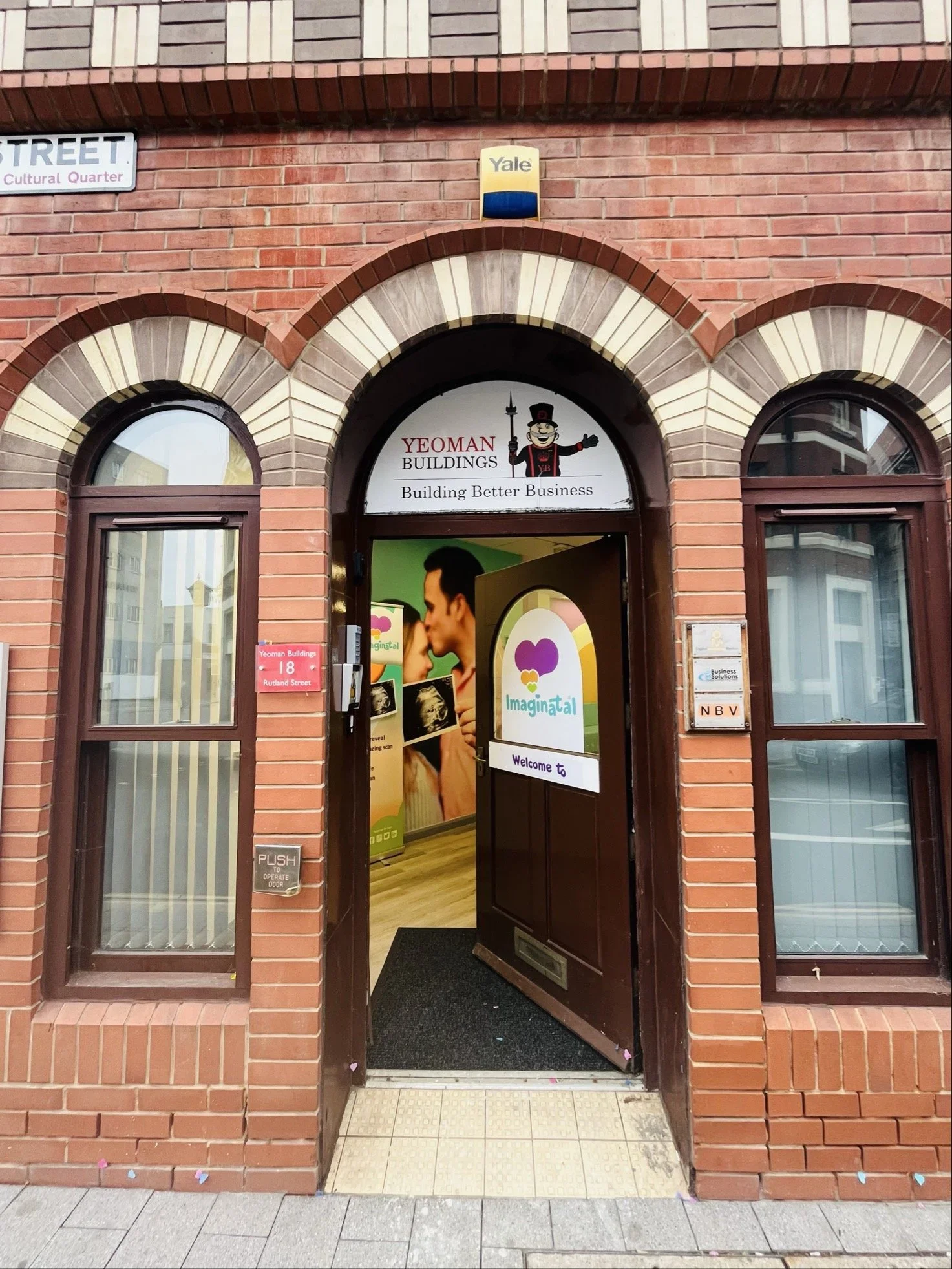 Bright and welcoming waiting area at Imaginatal Leicester with colourful walls, cosy sofas, display cases with baby toys and a calm space for private ultrasound and pregnancy scan appointments.