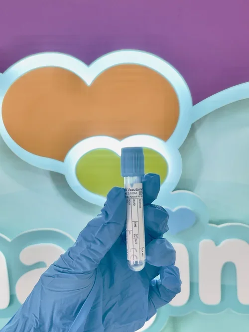 Light blue blood collection tube held by a clinician for private blood tests and health screening at Imaginatal