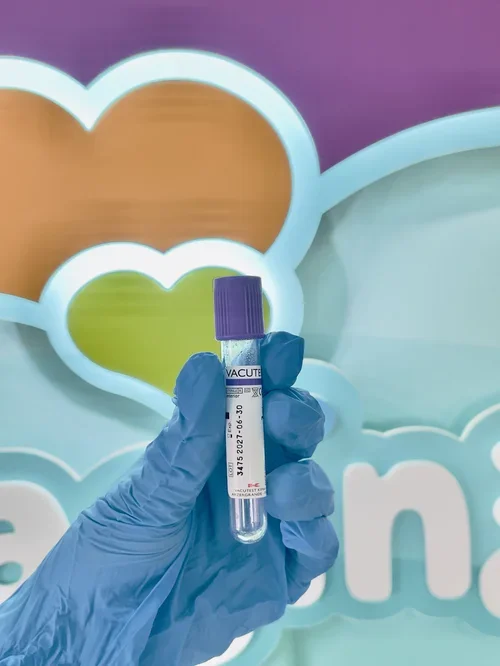 Purple blood collection tube held by a clinician for private blood tests and health screening at Imaginatal