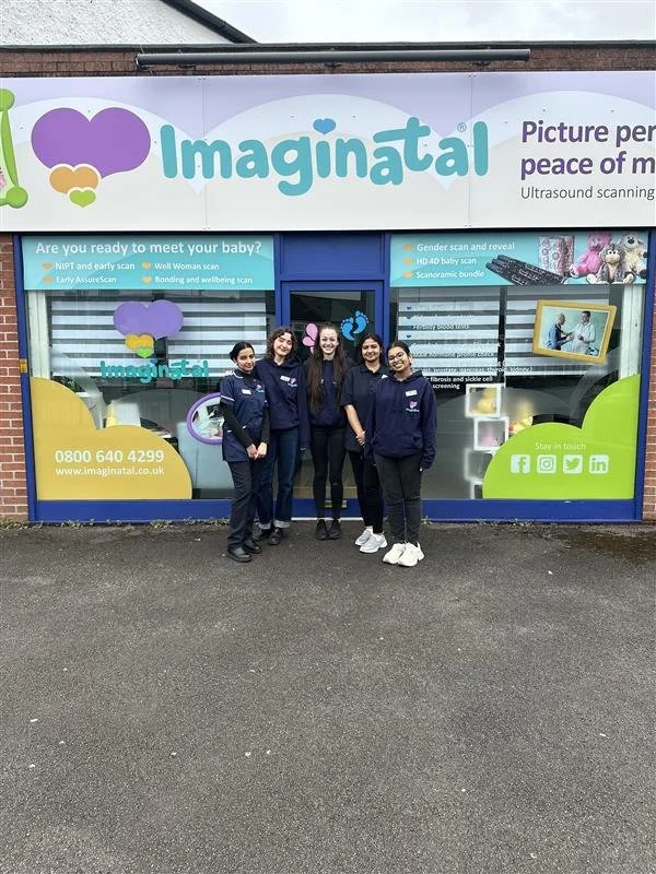 Imaginatal Cardiff clinic team standing outside the clinic entrance in front of the branded window.