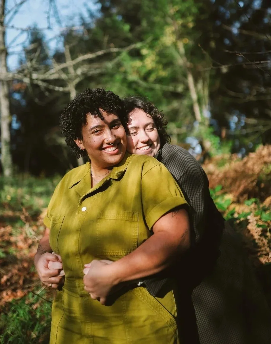 Two people hugging outdoors.