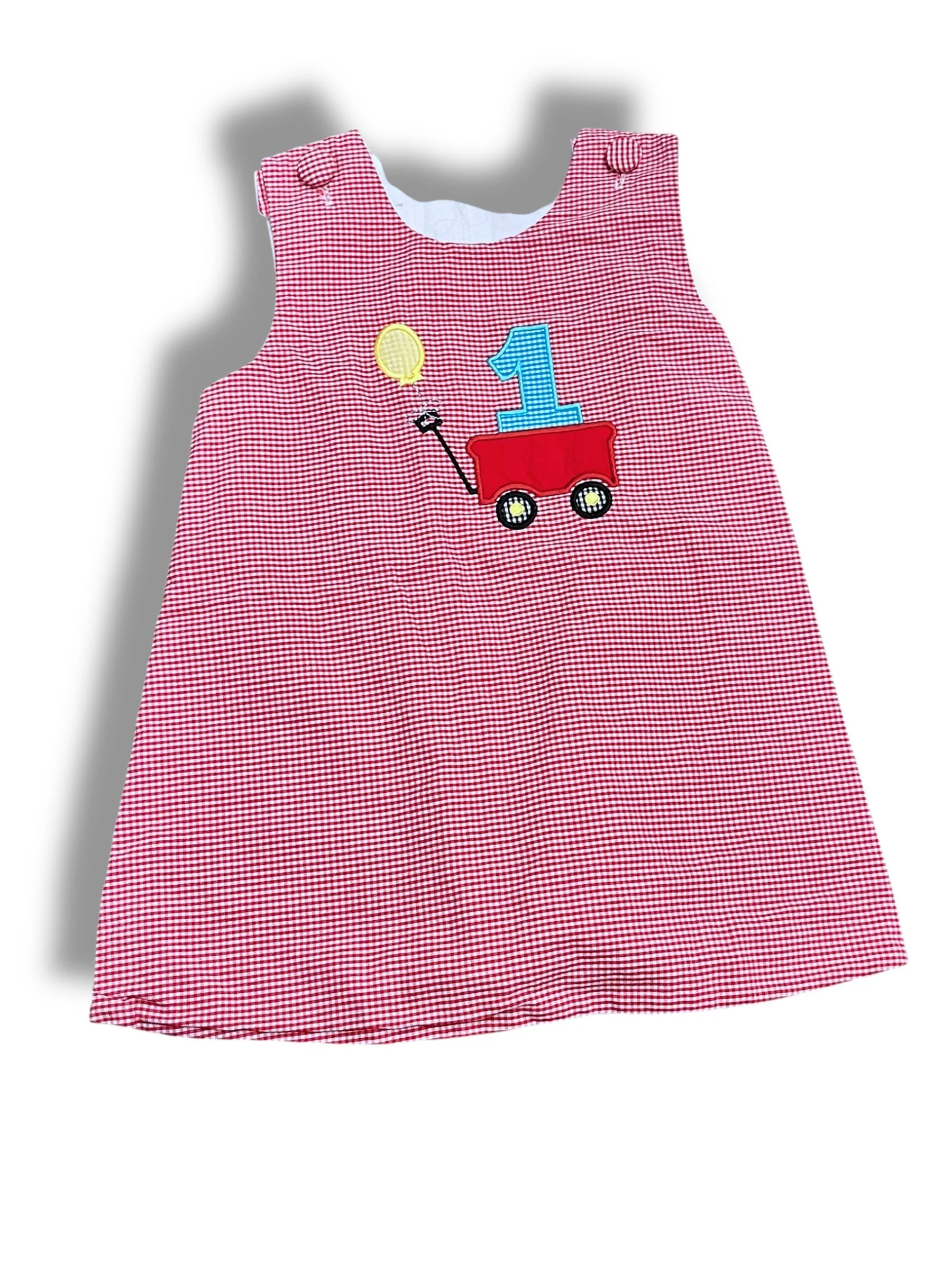 Size 12 month red gingham dress with "1" in a wagon