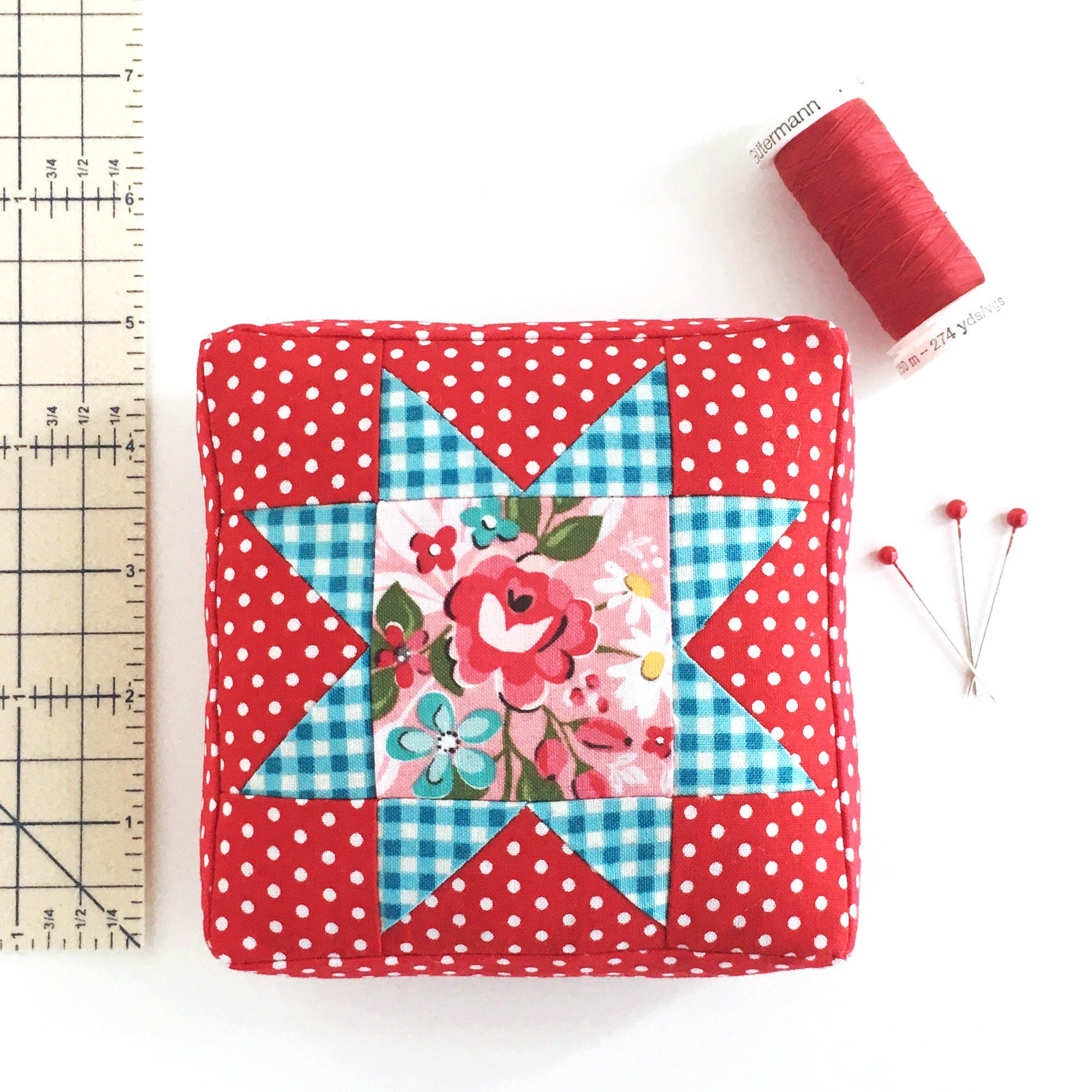 Example of the largest size in the Sawtooth Star Pincushion PDF sewing pattern with a ruler for size reference.