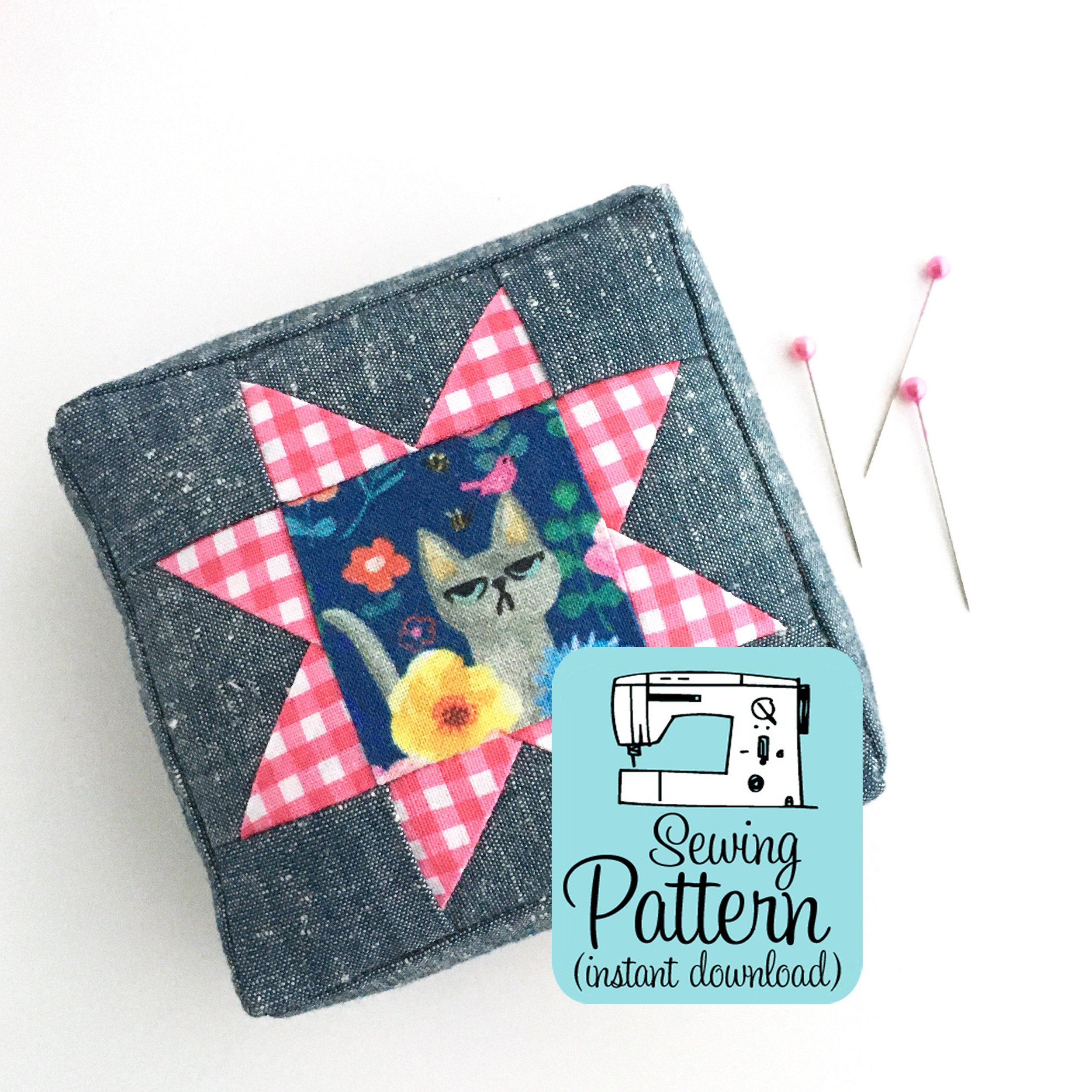 Square chambray and quilting cotton pin cushion with sewing pattern graphic.