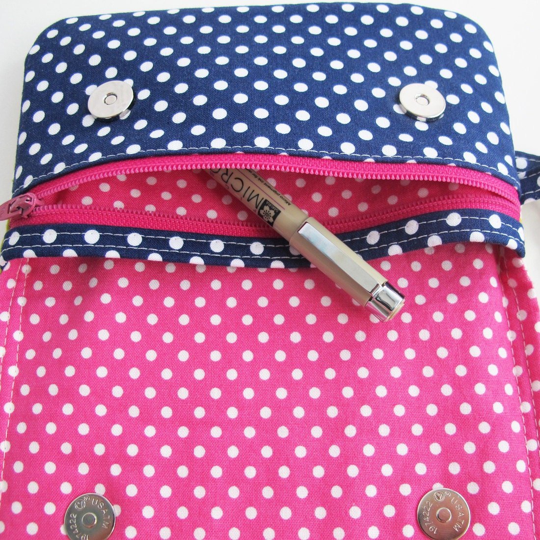 Close up of the zippered pocket on the front of the bags.