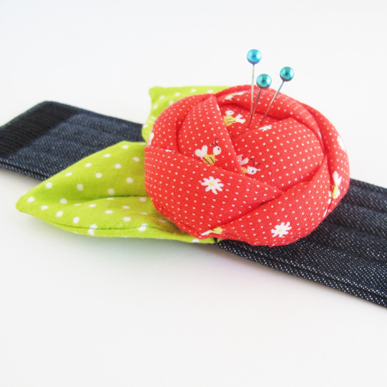 Red Rose Pincushion Cuff made from a Cosmo fabric with tiny bees.
