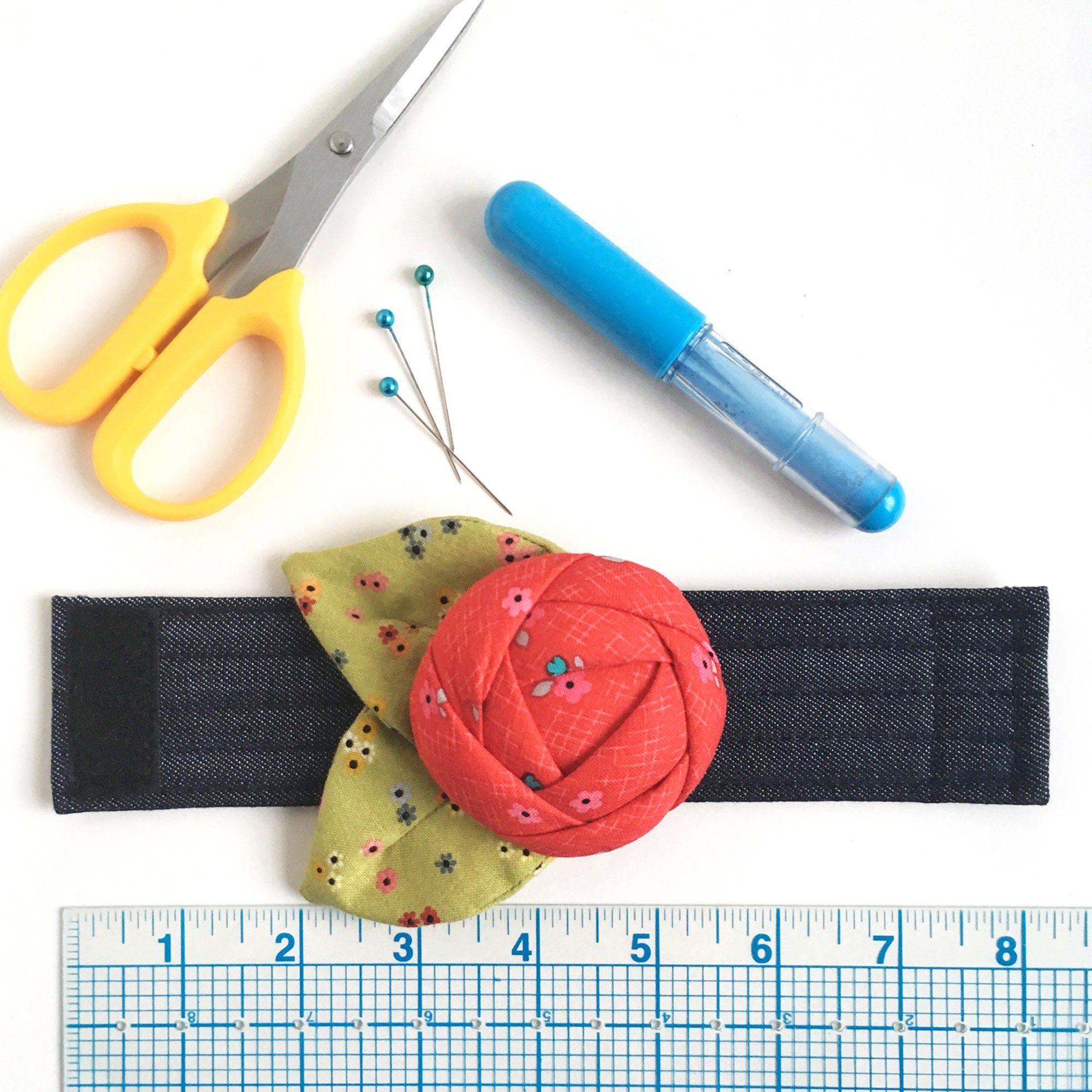 Pincushion cuff with ruler for size reference.