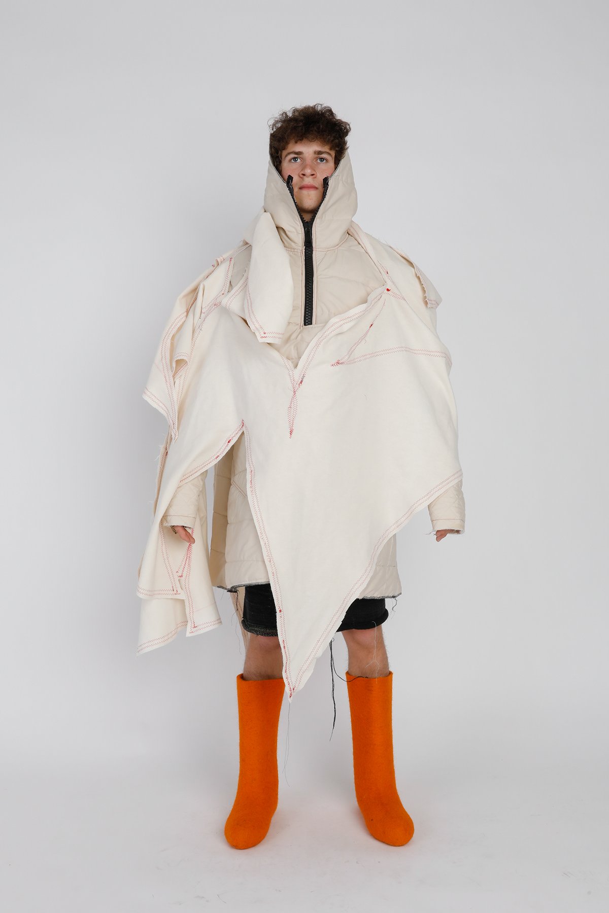 Repurposed fleece from window drapes This look is about finding new life for the material that has been long-forgotten. To create the graffiti overcoat, I drafted and cut it off the wall to preserve the original format and proportions to the actual