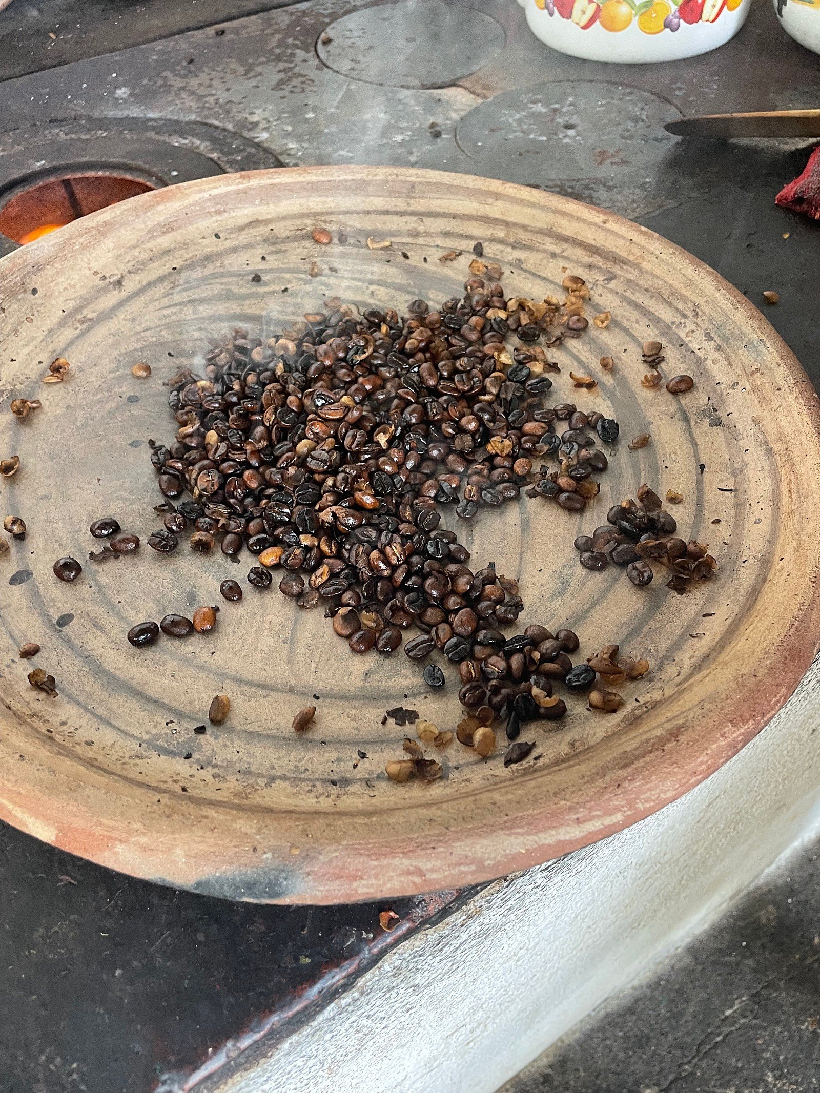 roasted coffee on a clay pan | coffee farm tour in antigua