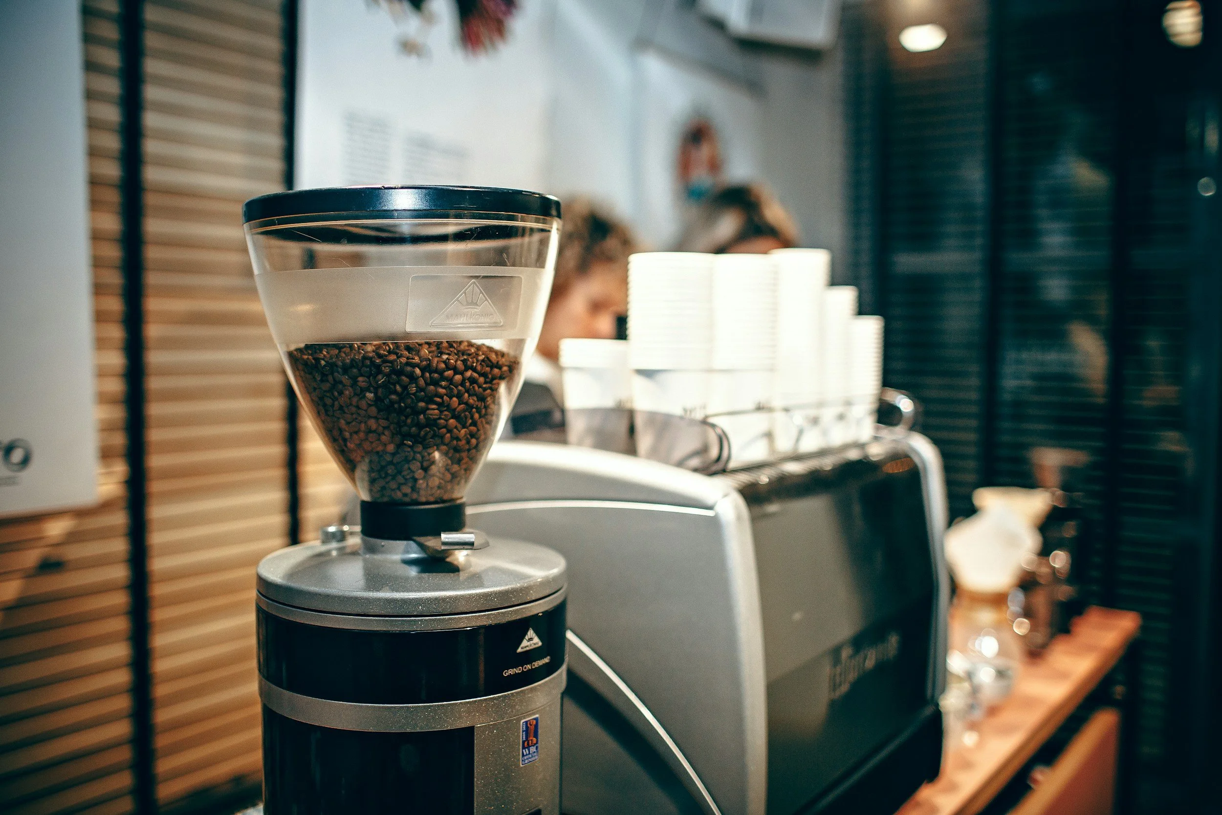 Roasted coffee beans in hopper ready to grind | Roasted coffe beans