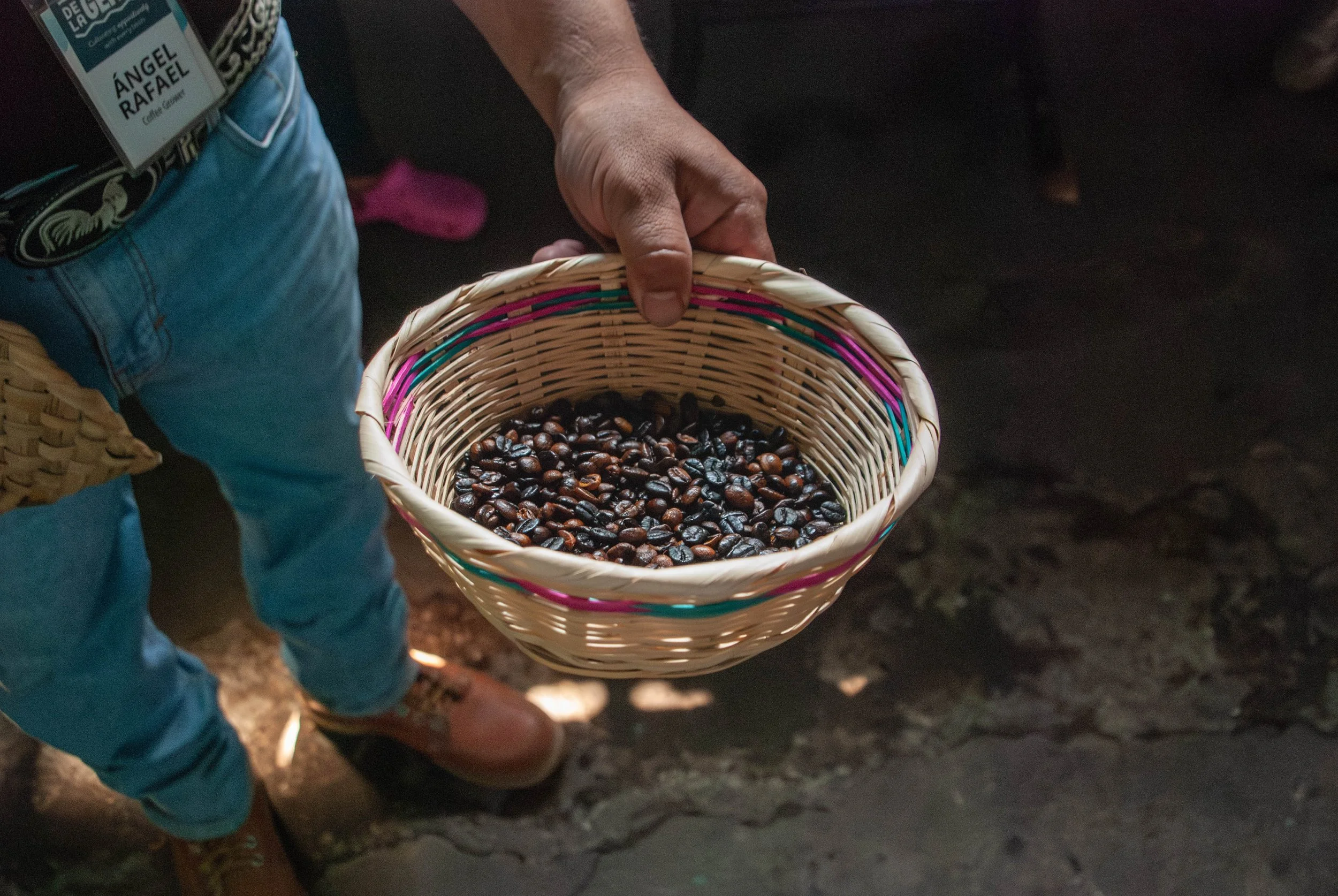 Coffee producer holding basket with roasted coffee beans | impact of fluctuations on C market on coffee producing communities